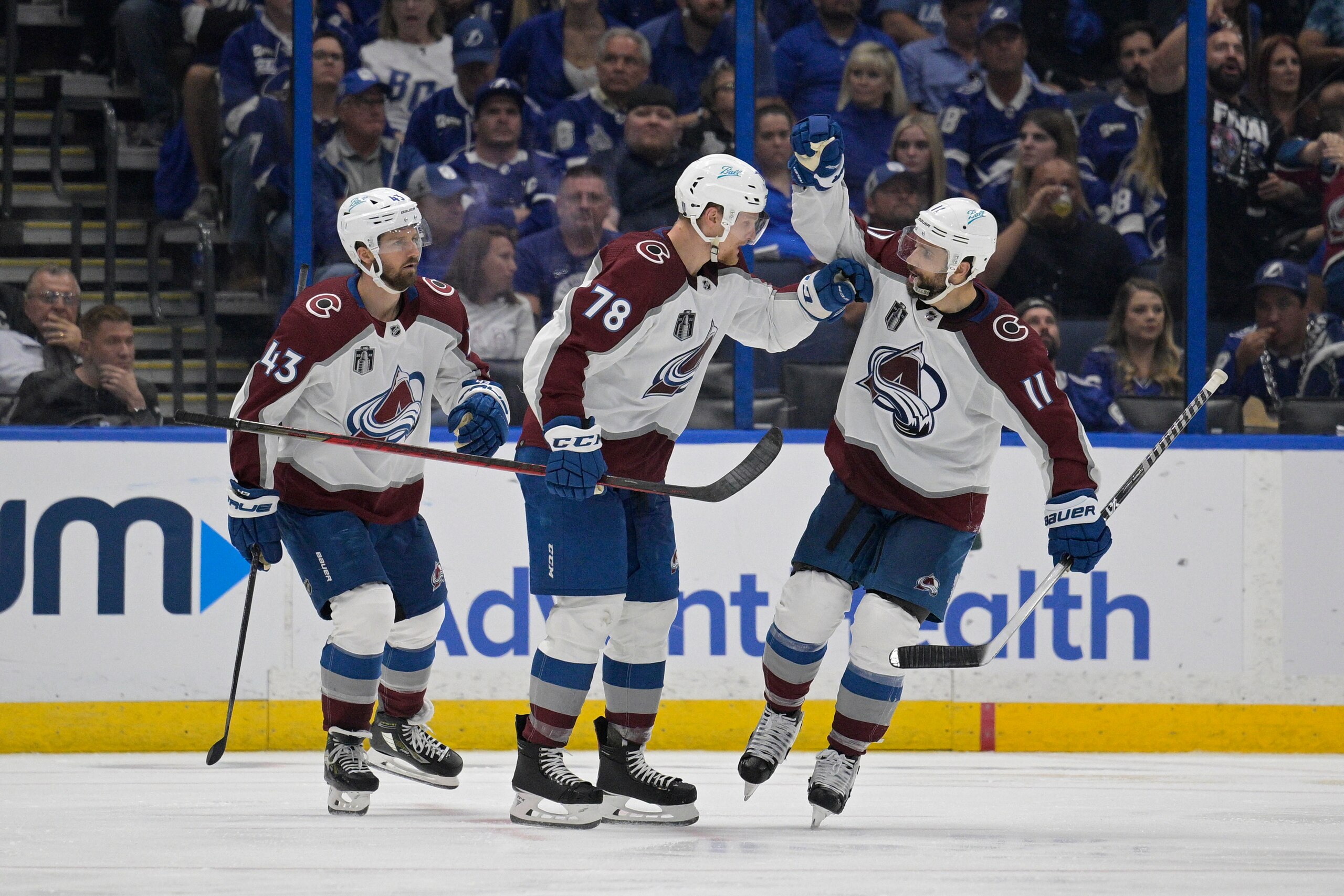 Colorado Avalanche center Andrew Cogliano (11) is congratulated by teammate Nico Sturm (78) after scoring during the third period of Game 4 of the NHL hockey Stanley Cup Finals against the Tampa Bay Lightning on Wednesday, June 22, 2022, in Tampa, Fla. (AP Photo/Phelan Ebenhack)