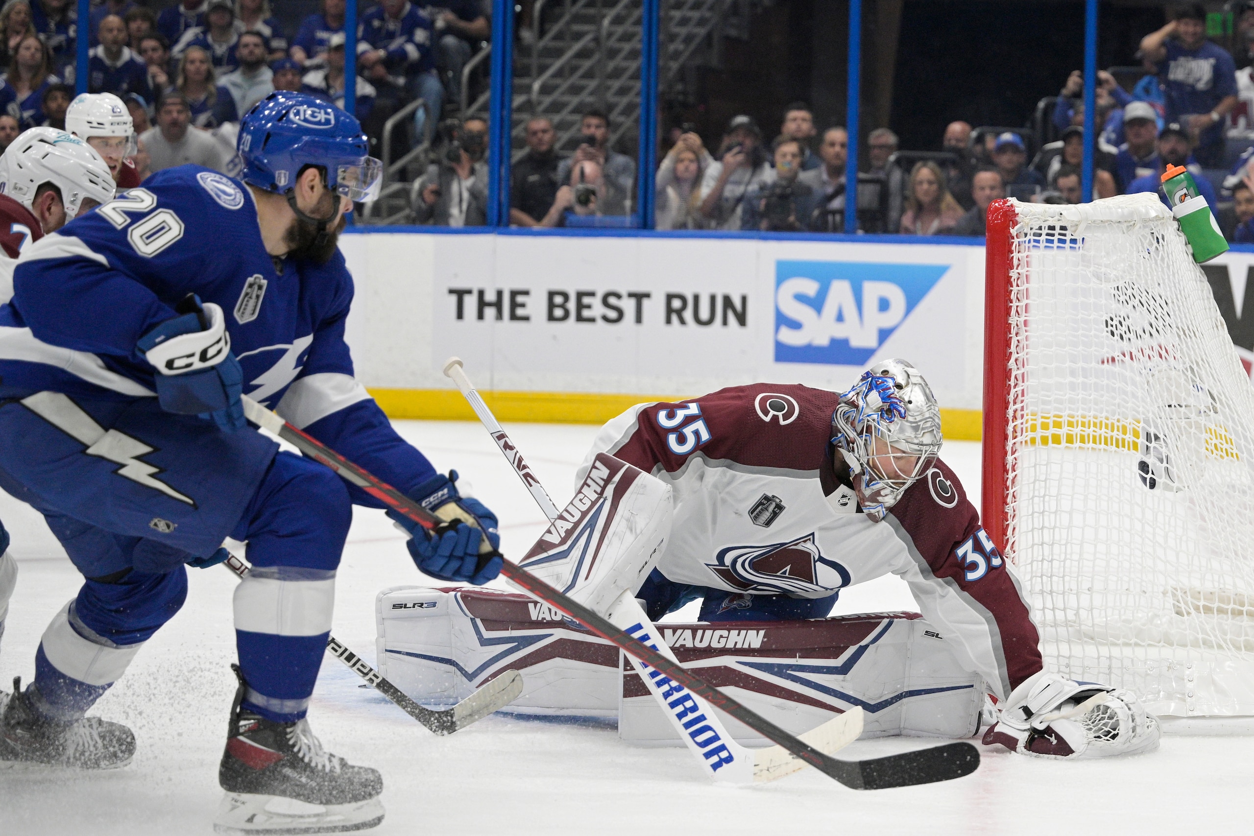 Colorado Avalanche goaltender Darcy Kuemper (35) makes a save in front of Tampa Bay Lightning left wing Nicholas Paul (20) during the first period of Game 4 of the NHL hockey Stanley Cup Finals on Wednesday, June 22, 2022, in Tampa, Fla. (AP Photo/Phelan Ebenhack)