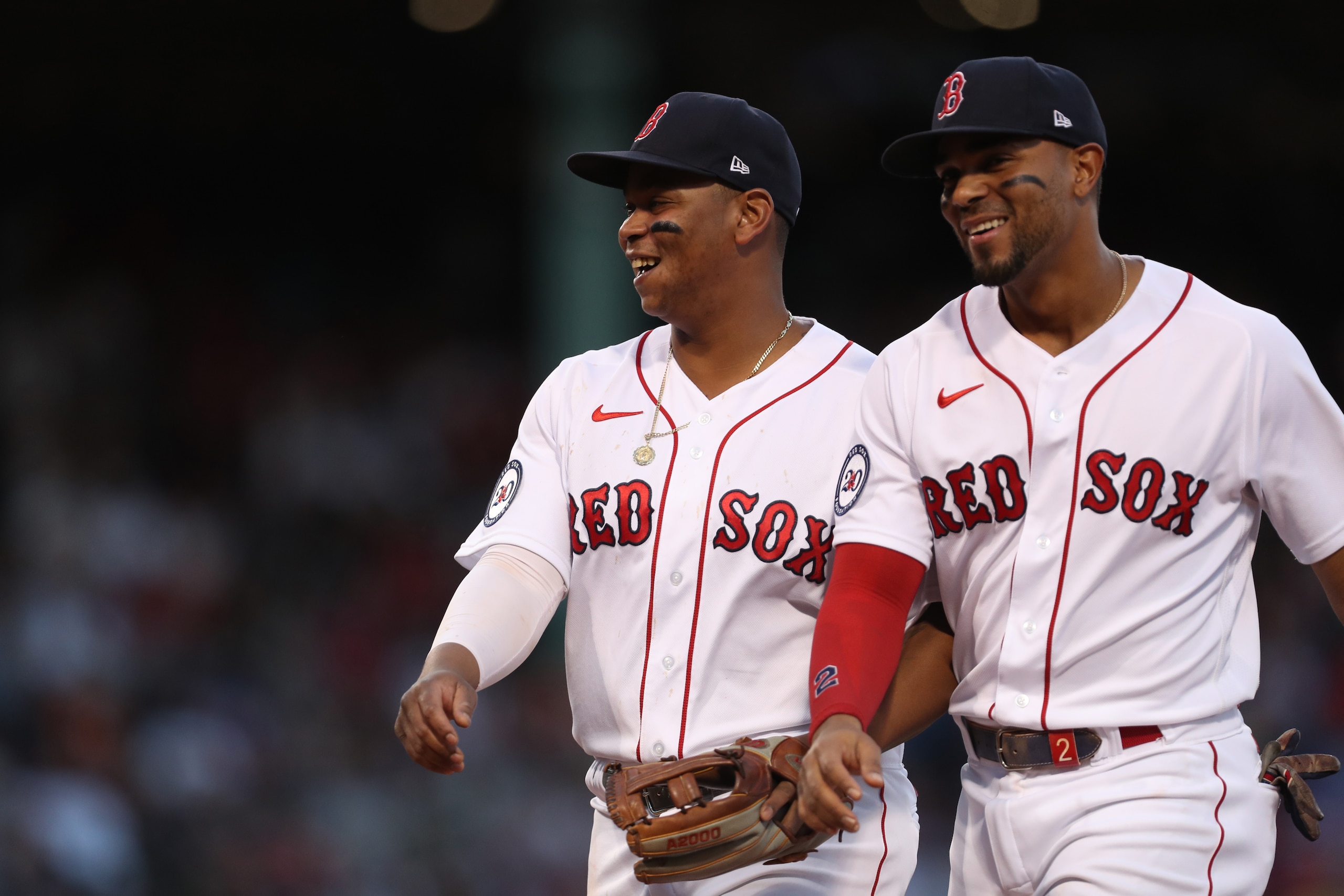 BOSTON, MASSACHUSETTS - JUNE 17: Rafael Devers #11 and Xander Bogaerts #2 of the Boston Red Sox walk off the field during the fourth inning against the St. Louis Cardinals at Fenway Park on June 17, 2022 in Boston, Massachusetts. (Photo by Paul Rutherford/Getty Images)