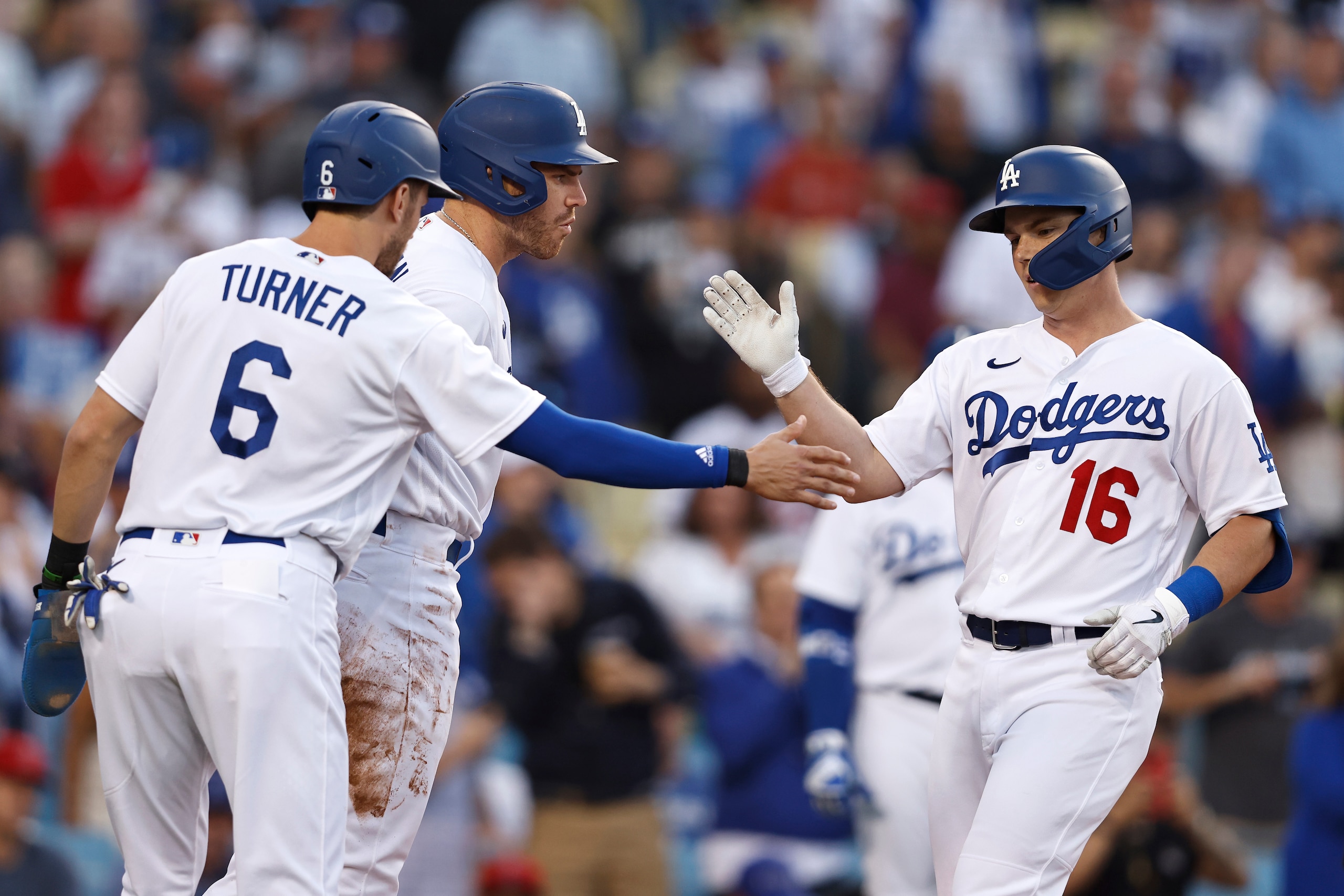 LOS ANGELES, CALIFORNIA - JUNE 15: Will Smith #16 of the Los Angeles Dodgers celebrates with teammates Trea Turner #6 and Freddie Freeman #5 after hitting a three-run home run against the Los Angeles Angels during the first inning at Dodger Stadium on June 15, 2022 in Los Angeles, California. (Photo by Michael Owens/Getty Images)