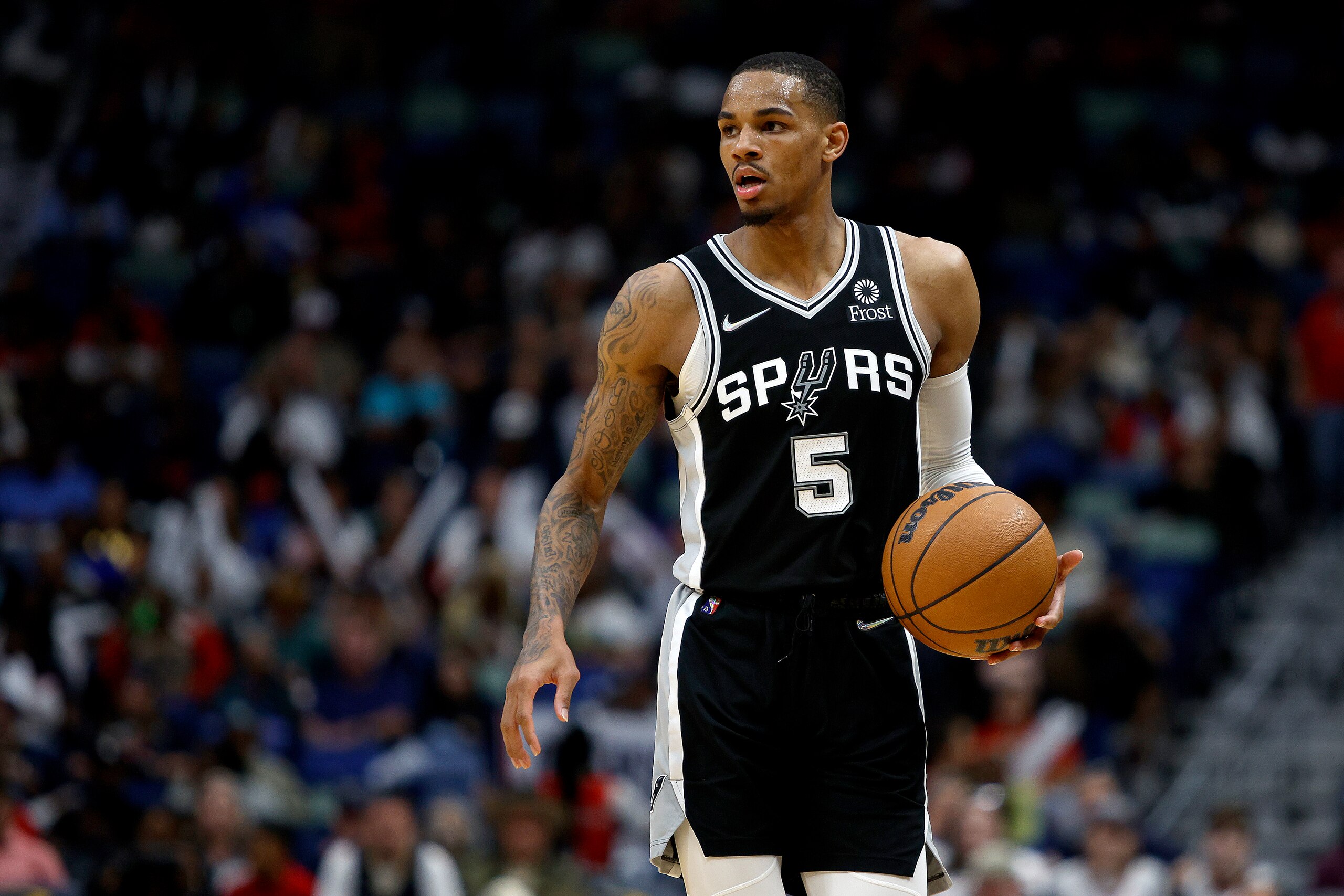 NEW ORLEANS, LOUISIANA - MARCH 26: Dejounte Murray #5 of the San Antonio Spurs dribbles the ball down court during the third quarter of an NBA game against the New Orleans Pelicans at Smoothie King Center on March 26, 2022 in New Orleans, Louisiana. San Antonio Spurs won the game 107 - 103. NOTE TO USER: User expressly acknowledges and agrees that, by downloading and or using this photograph, User is consenting to the terms and conditions of the Getty Images License Agreement. (Photo by Sean Gardner/Getty Images)