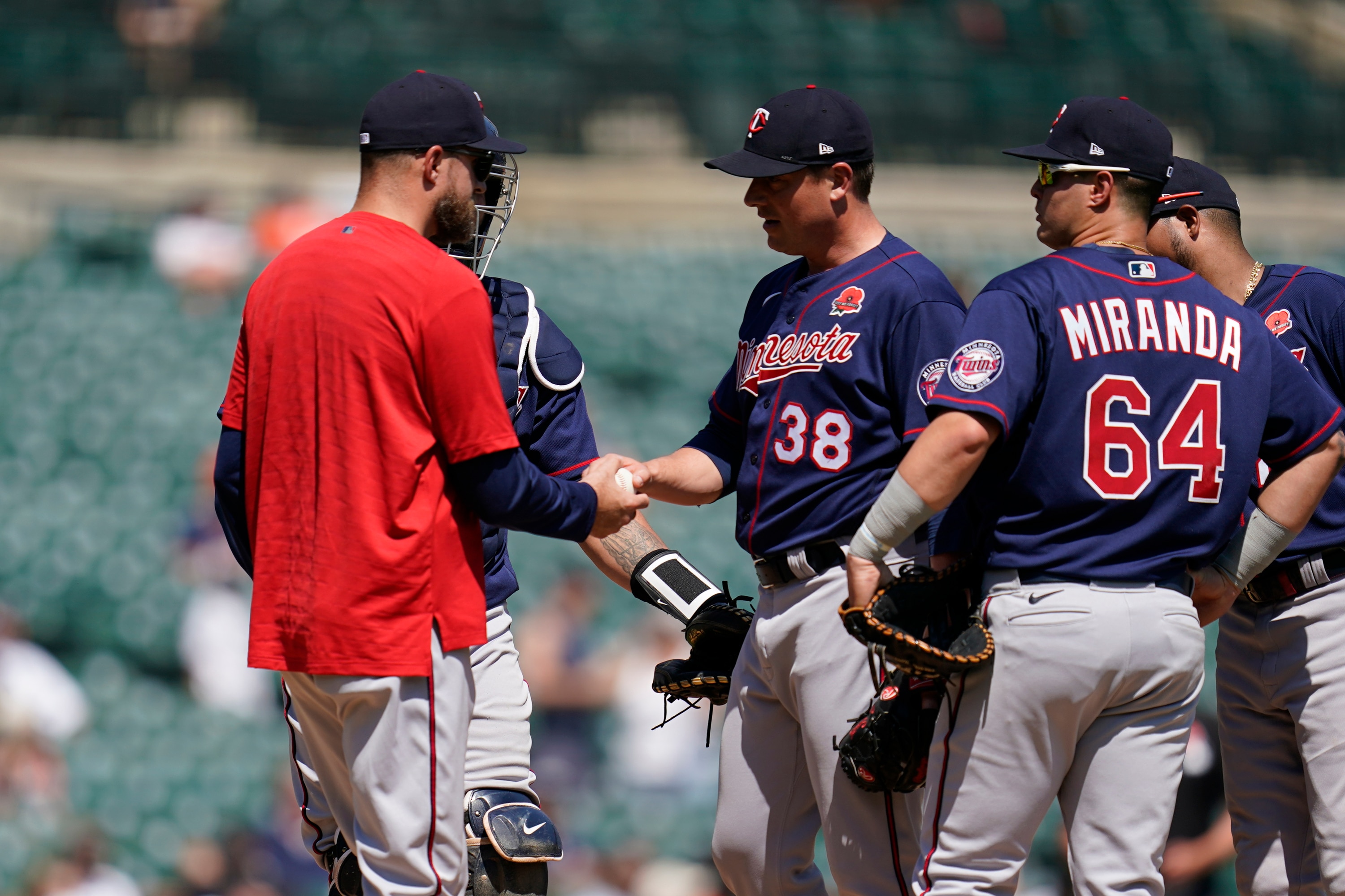 Minnesota Twins manager Rocco Baldelli takes the ball from relief pitcher Joe Smith (38) in the seventh inning of a baseball game in Detroit, Monday, May 30, 2022. (AP Photo/Paul Sancya)