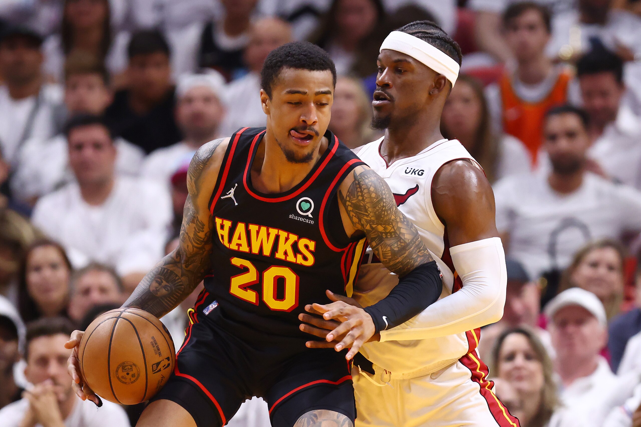 MIAMI, FLORIDA - APRIL 19: John Collins #20 of the Atlanta Hawks drives to the basket against Jimmy Butler #22 of the Miami Heat during the fourth quarter in Game Two of the Eastern Conference First Round at FTX Arena on April 19, 2022 in Miami, Florida. NOTE TO USER: User expressly acknowledges and agrees that, by downloading and or using this photograph, User is consenting to the terms and conditions of the Getty Images License Agreement.  (Photo by Michael Reaves/Getty Images)