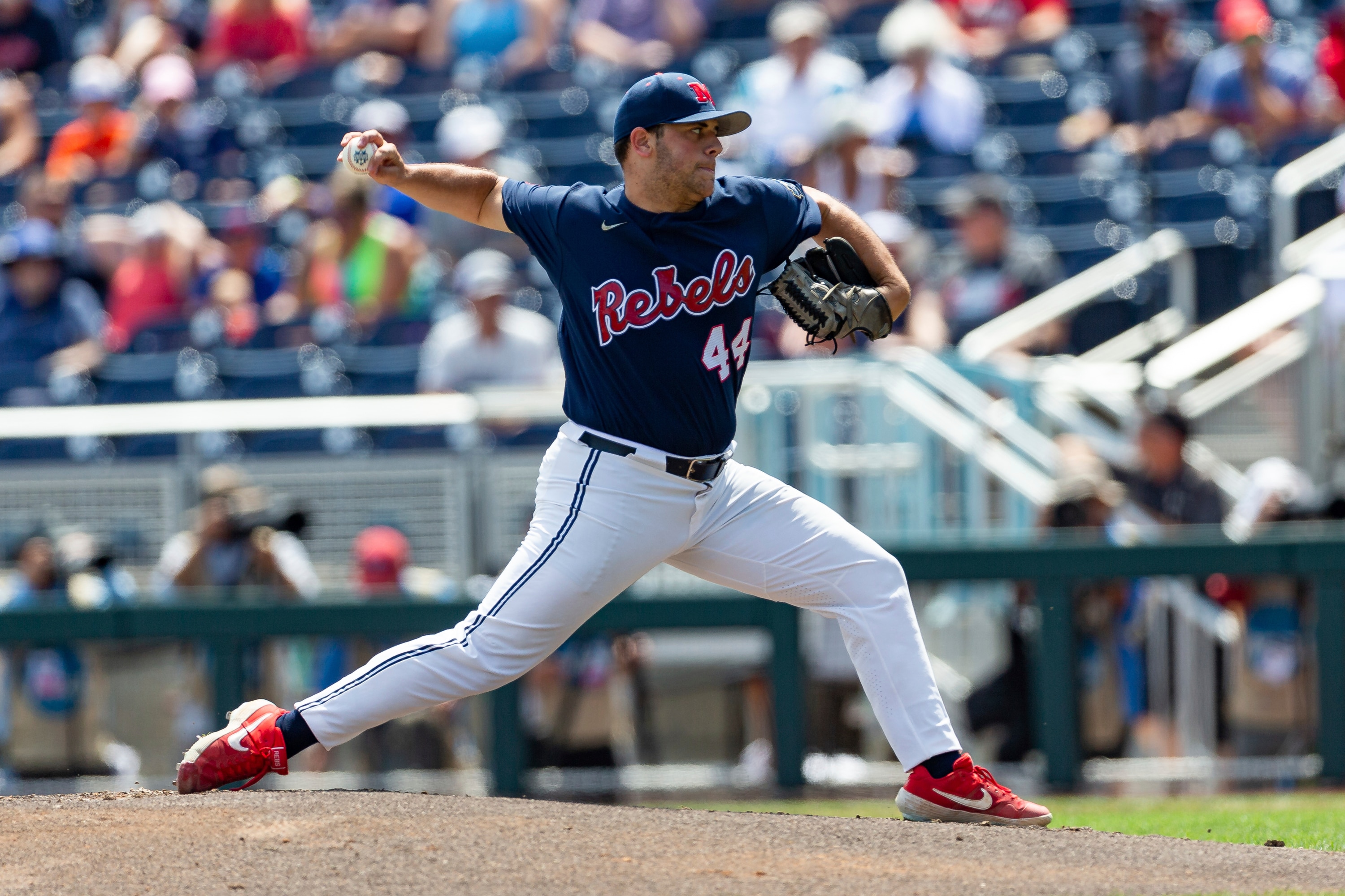 Mississippi staring pitcher Dylan DeLucia (44) throws a pitch in the first inning against Arkansas during an NCAA College World Series baseball game Thursday, June 23, 2022, in Omaha, Neb. (AP Photo/John Peterson)