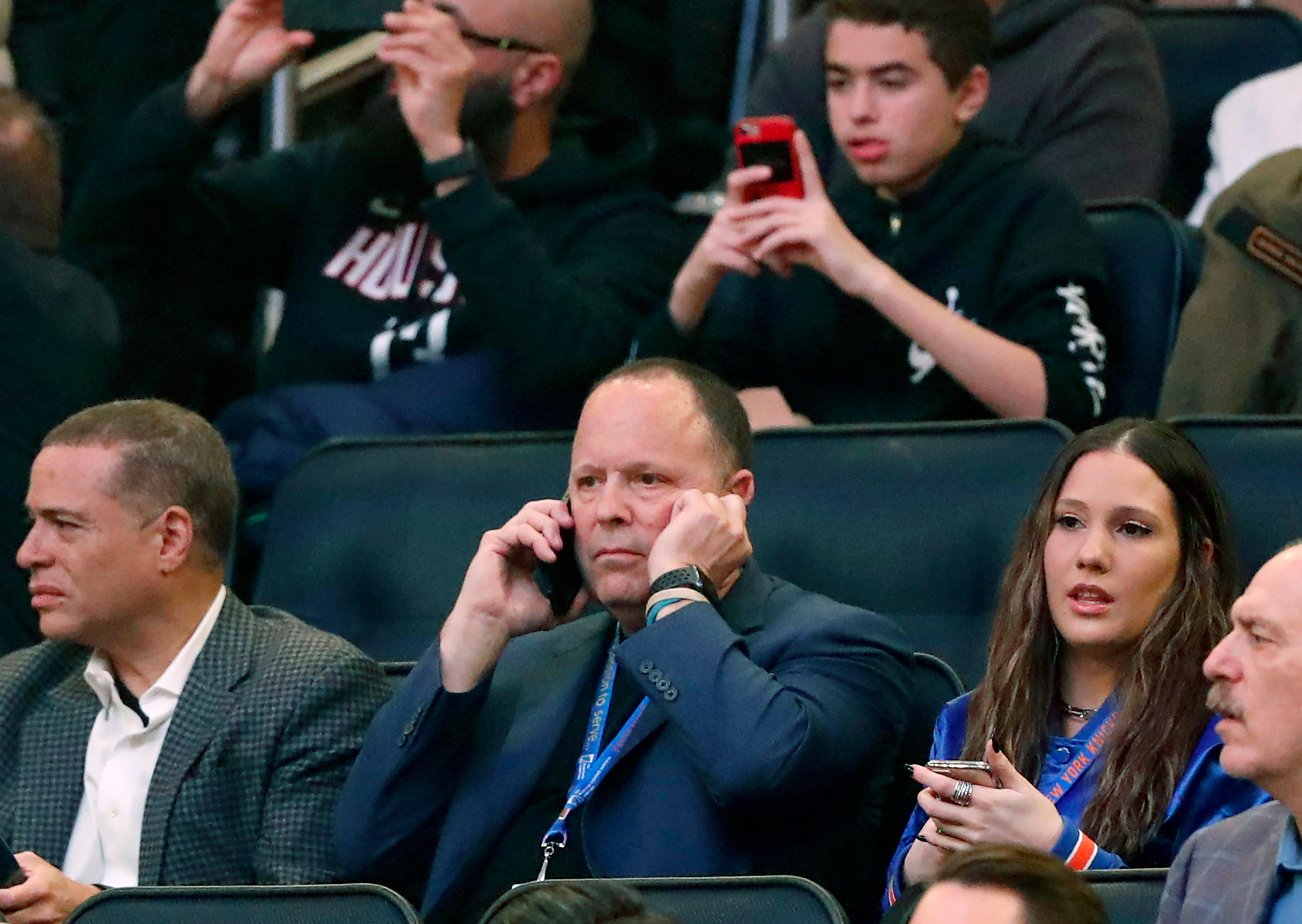 Former player agent and new New York Knicks president Leon Rose, center, takes a phone call during the first quarter of an NBA basketball game against the Houston Rockets in New York, Monday, March 2, 2020. (AP Photo/Kathy Willens)