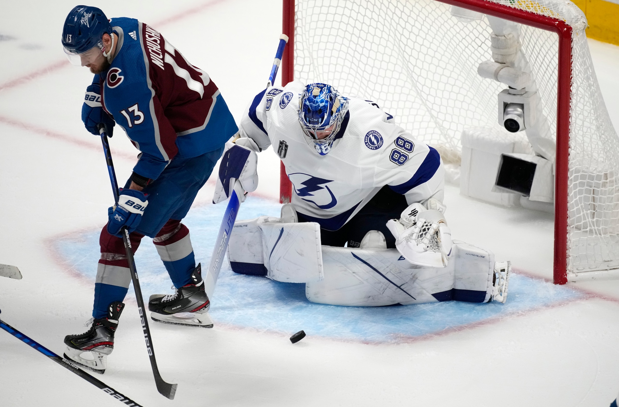 Colorado Avalanche right wing Valeri Nichushkin, left, redirects the puck at Tampa Bay Lightning goaltender Andrei Vasilevskiy during the third period of Game 5 of the NHL hockey Stanley Cup Final, Friday, June 24, 2022, in Denver. (AP Photo/David Zalubowski)