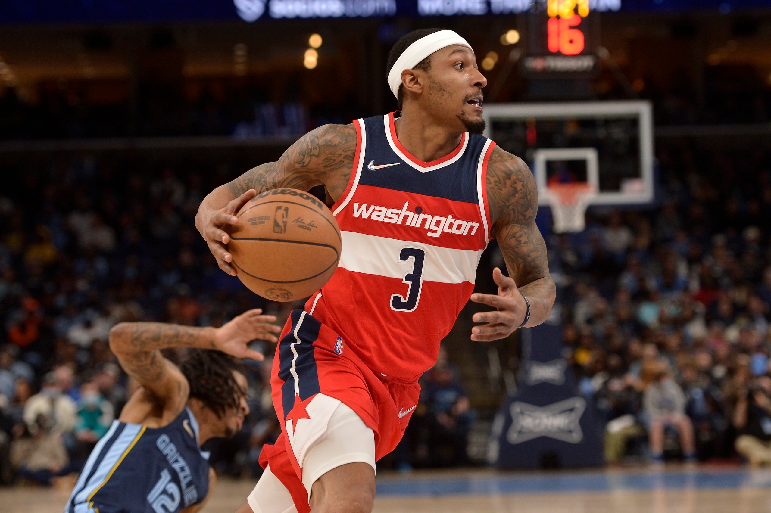 Washington Wizards guard Bradley Beal (3) drives to the basket ahead of Memphis Grizzlies guard Ja Morant (12) in the second half of an NBA basketball game Saturday, Jan. 29, 2022, in Memphis, Tenn. (AP Photo/Brandon Dill)