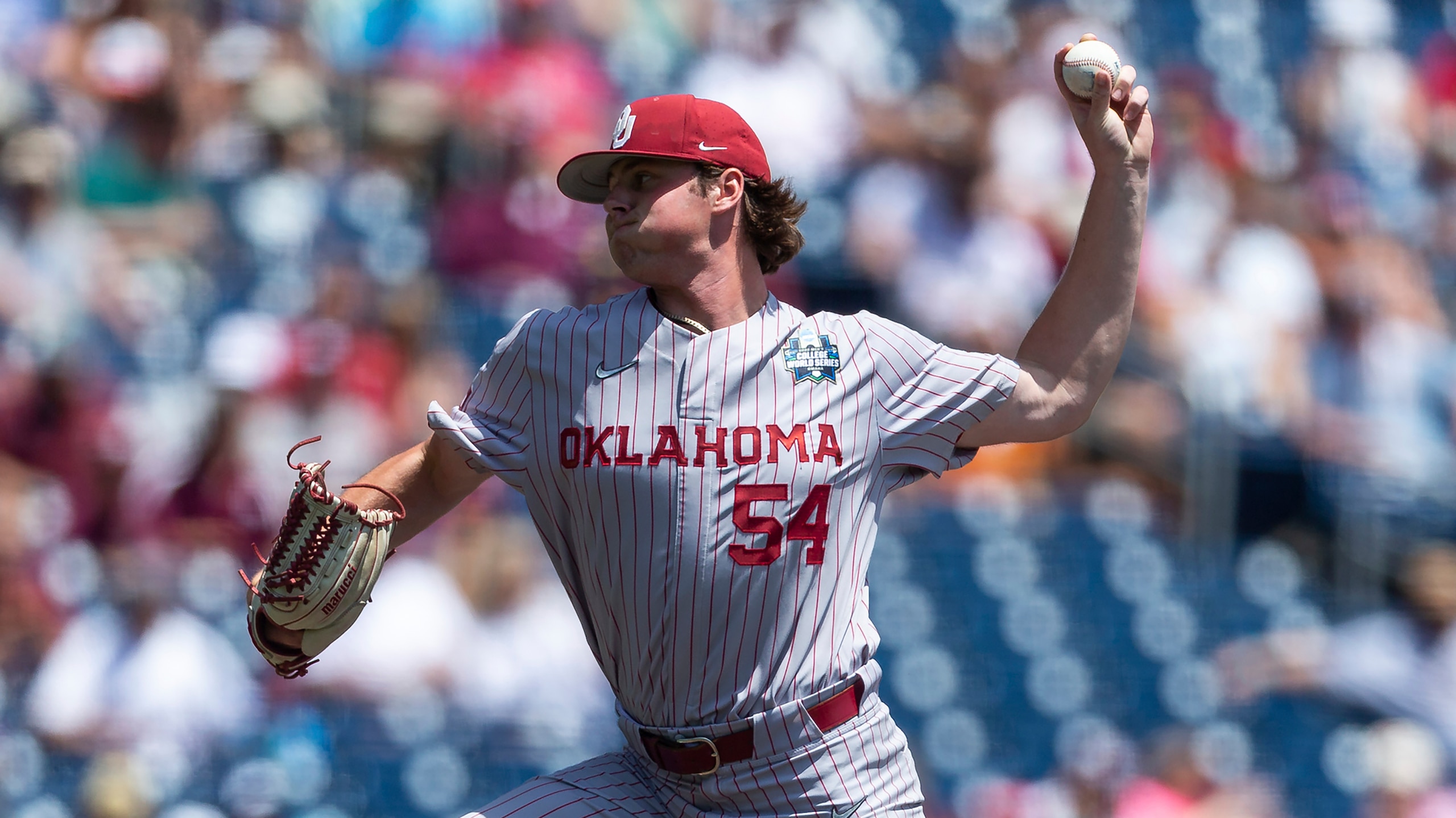 Oklahoma pitcher Jake Bennett (54) throws a pitch against Texas A&M in the first inning during an NCAA College World Series baseball game Friday, June 17, 2022, in Omaha, Neb. (AP Photo/John Peterson)
