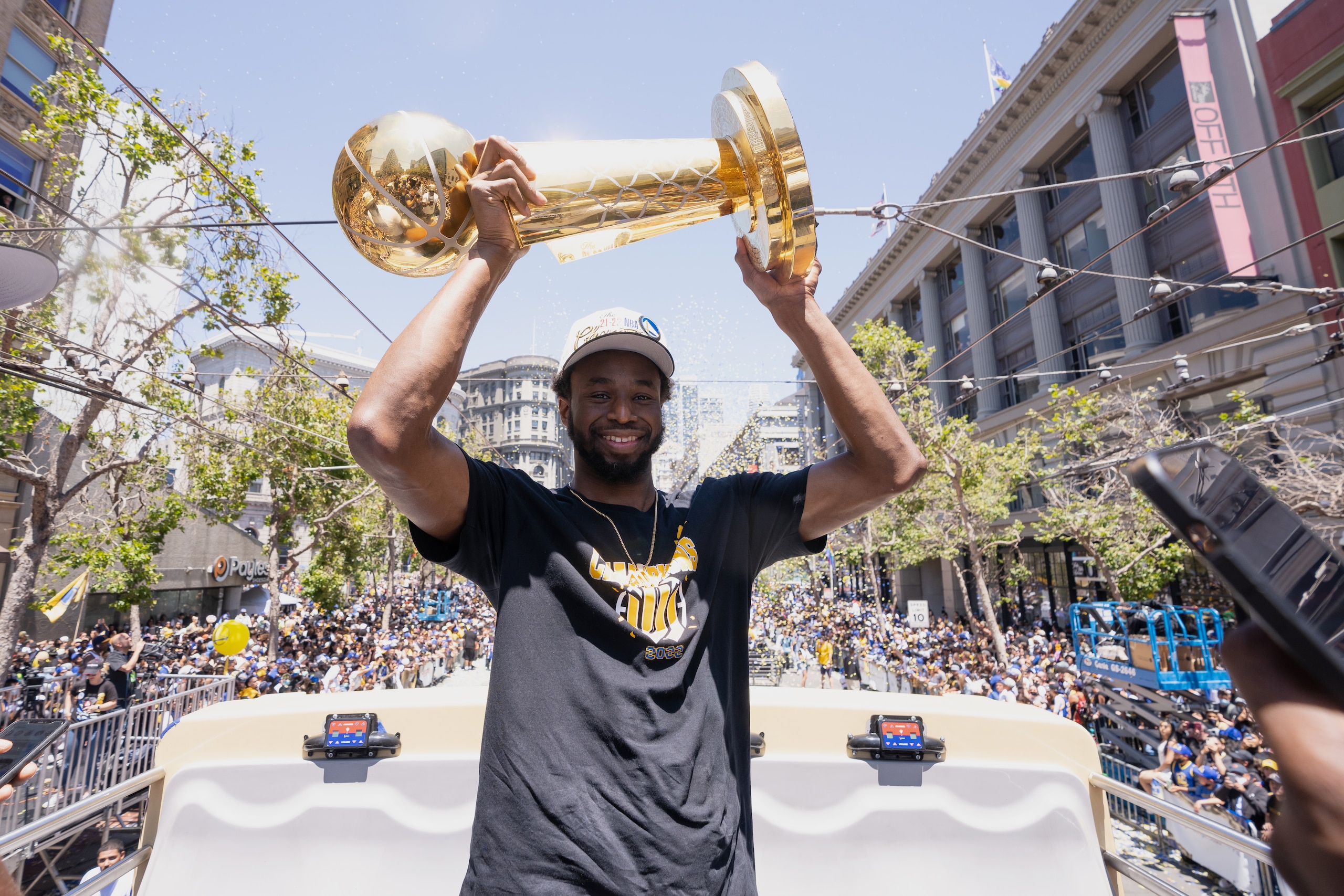 SAN FRANCISCO, CA - JUNE 20: Andrew Wiggins #22 of the Golden State Warriors smiles while holding the Larry OBrien Trophy during the 2022 Victory Parade & Rally on June 20, 2022 at Chase Center in San Francisco, California. NOTE TO USER: User expressly acknowledges and agrees that, by downloading and or using this photograph, user is consenting to the terms and conditions of Getty Images License Agreement. Mandatory Copyright Notice: Copyright 2022 NBAE (Photo by Josh Leung/NBAE via Getty Images)