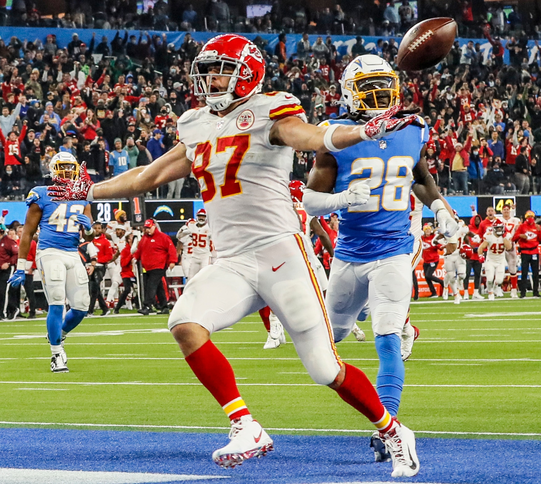 Inglewood, CA, Thursday, December 16, 2021 - Kansas City Chiefs tight end Travis Kelce (87) scores the game winning touchdown in overtime past Los Angeles Chargers cornerback Davontae Harris (28) at SoFi Stadium. (Robert Gauthier/Los Angeles Times via Getty Images)