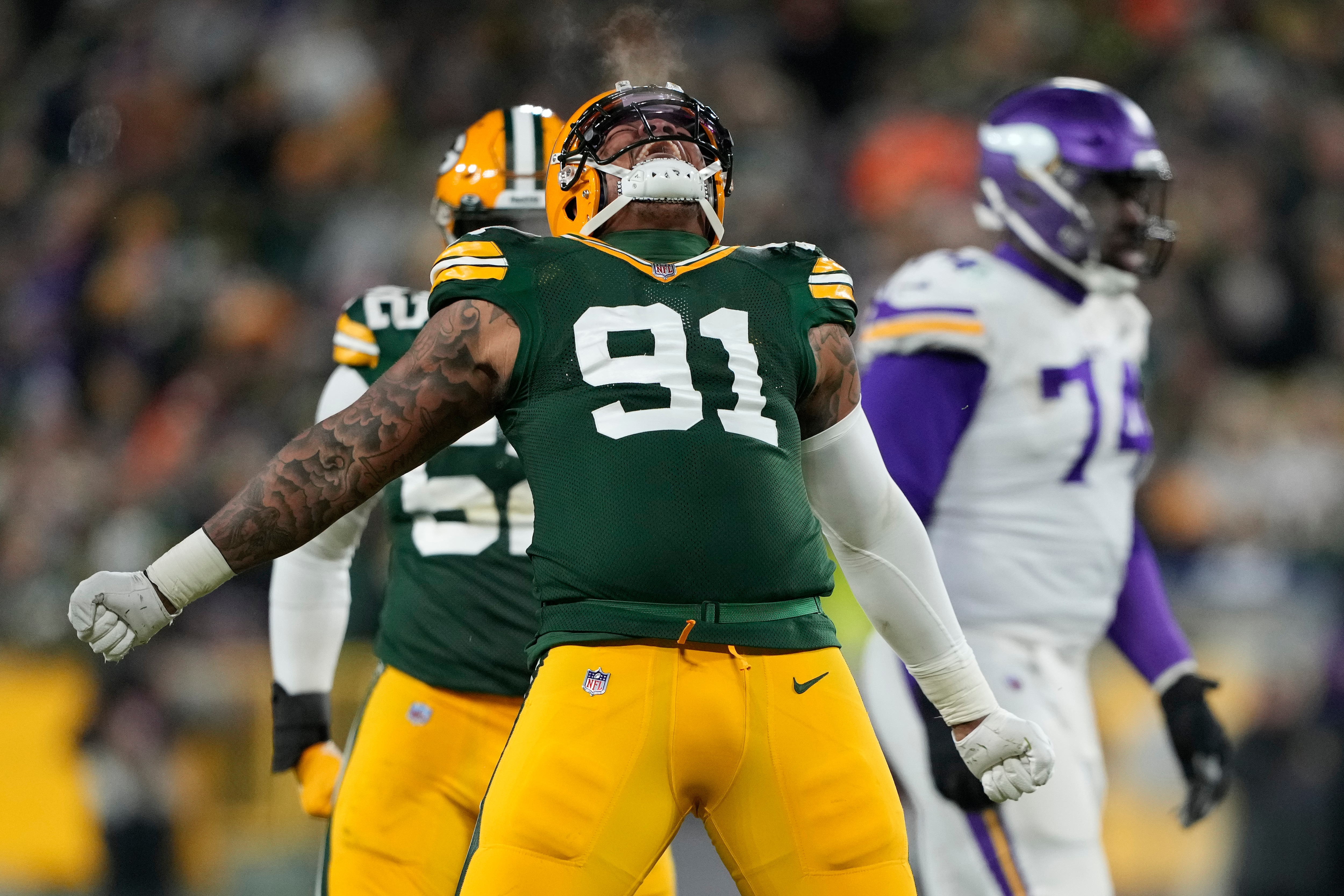 GREEN BAY, WISCONSIN - JANUARY 02: Outside linebacker Preston Smith #91 of the Green Bay Packers reacts after sacking quarterback Sean Mannion #14 of the Minnesota Vikings during the 2nd quarter of the game at Lambeau Field on January 02, 2022 in Green Bay, Wisconsin. (Photo by Patrick McDermott/Getty Images)