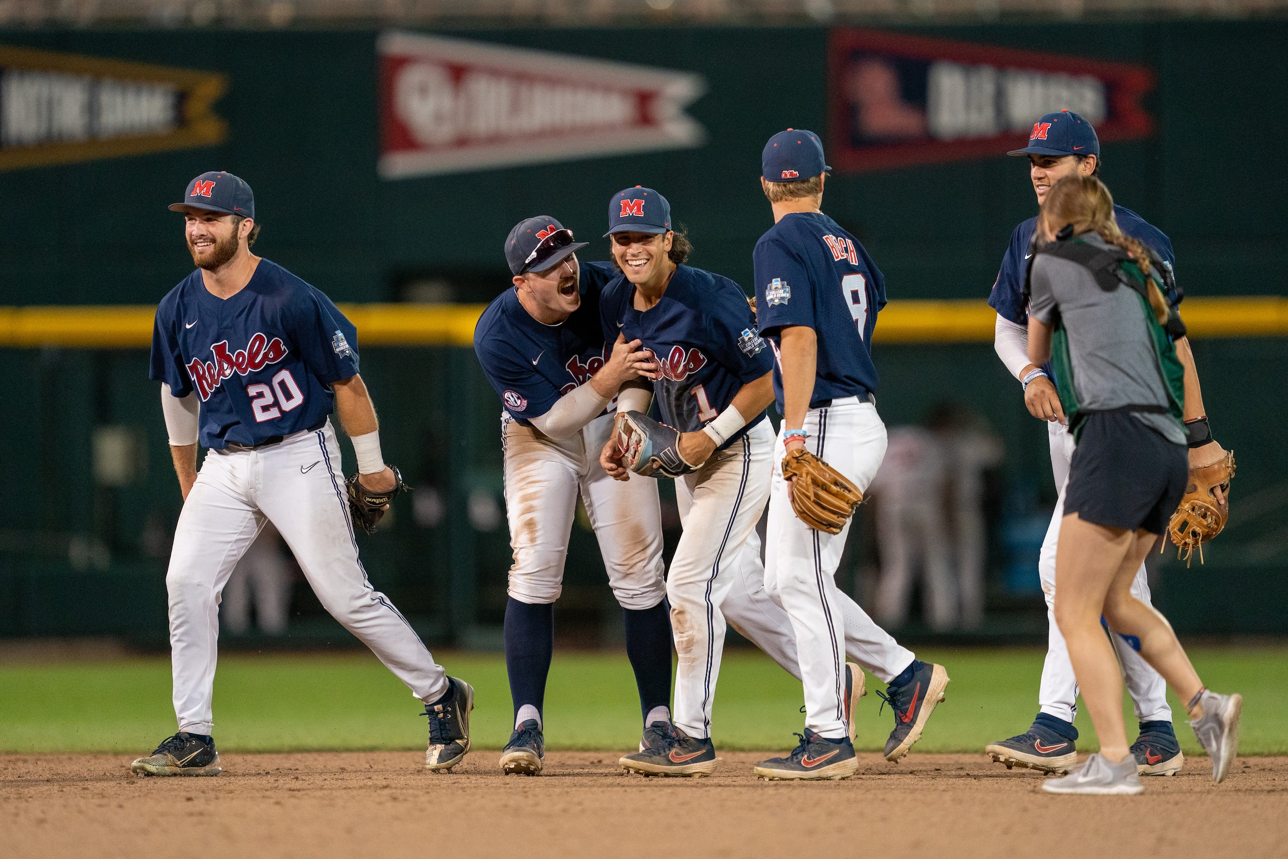 OMAHA, NE - JUNE 25: Calvin Harris #20, Tim Elko #25, and Peyton Chatagnier #1 of the Ole Miss Rebels celebrate after defeating the Oklahoma Sooners 10-3 in Game One of the Men's College World Series at Charles Schwab Field on June 25, 2022 in Omaha, Nebraska. (Photo by Eric Francis/Getty Images)