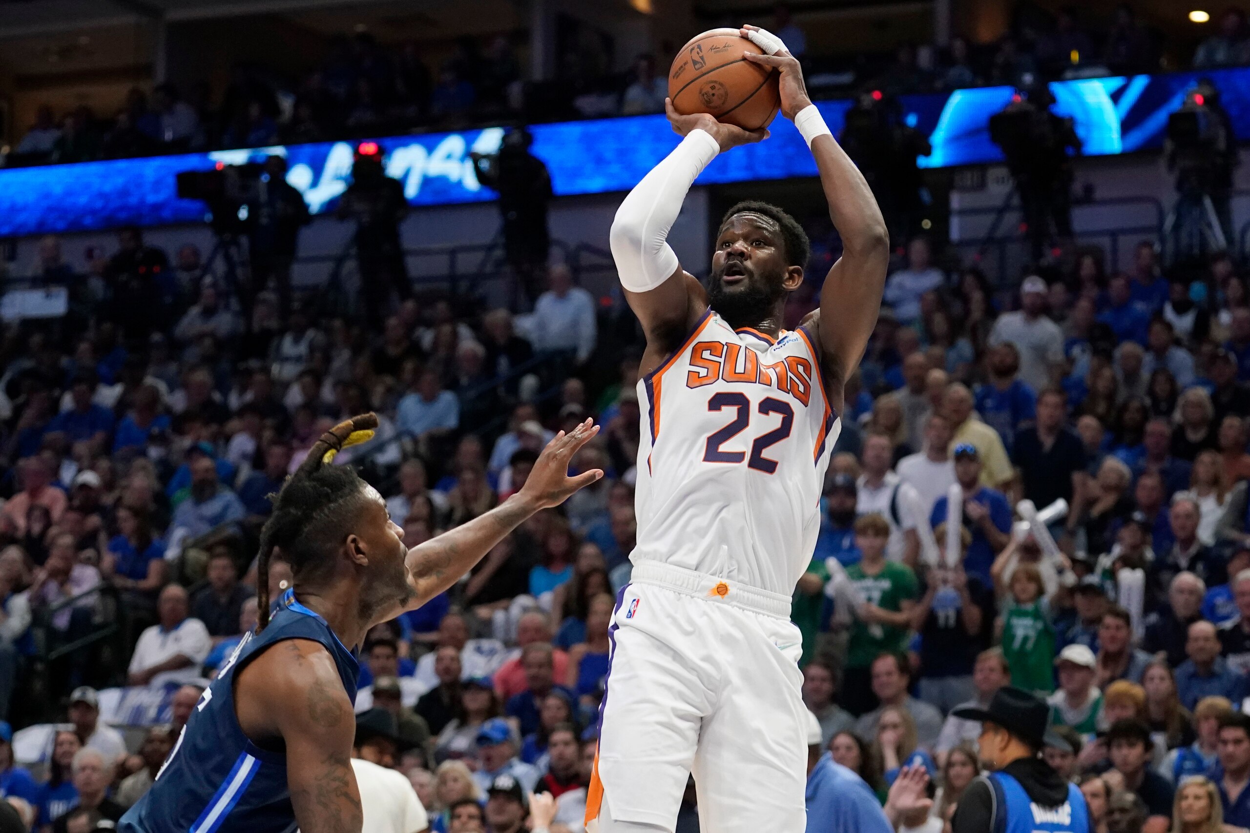 Phoenix Suns center Deandre Ayton (22) shoots over Dallas Mavericks forward Reggie Bullock, left, during the first half of Game 6 of an NBA basketball second-round playoff series, Thursday, May 12, 2022, in Dallas. (AP Photo/Tony Gutierrez)