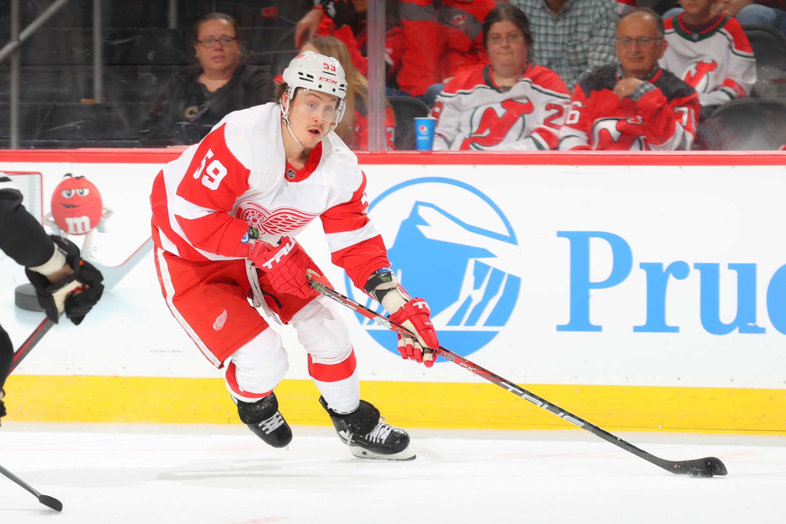NEWARK, NJ - APRIL  29:   Tyler Bertuzzi #59 of the Detroit Red Wings controls the puck against the New Jersey Devils on April 29, 2022 at the Prudential Center in Newark, New Jersey.  (Photo by Rich Graessle/Getty Images)