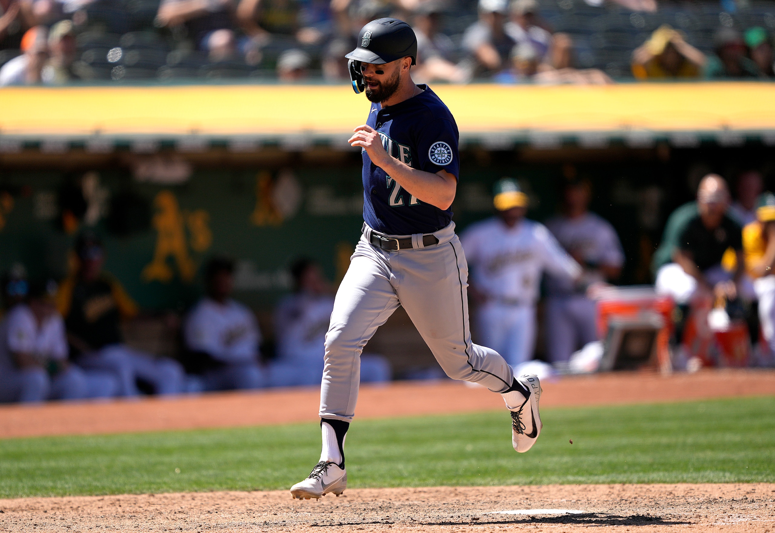 OAKLAND, CALIFORNIA - JUNE 23: Jesse Winker #27 of the Seattle Mariners scores on a wild pitch from A.J. Puk #33 of the Oakland Athletics in the top of the ninth inning at RingCentral Coliseum on June 23, 2022 in Oakland, California. (Photo by Thearon W. Henderson/Getty Images)