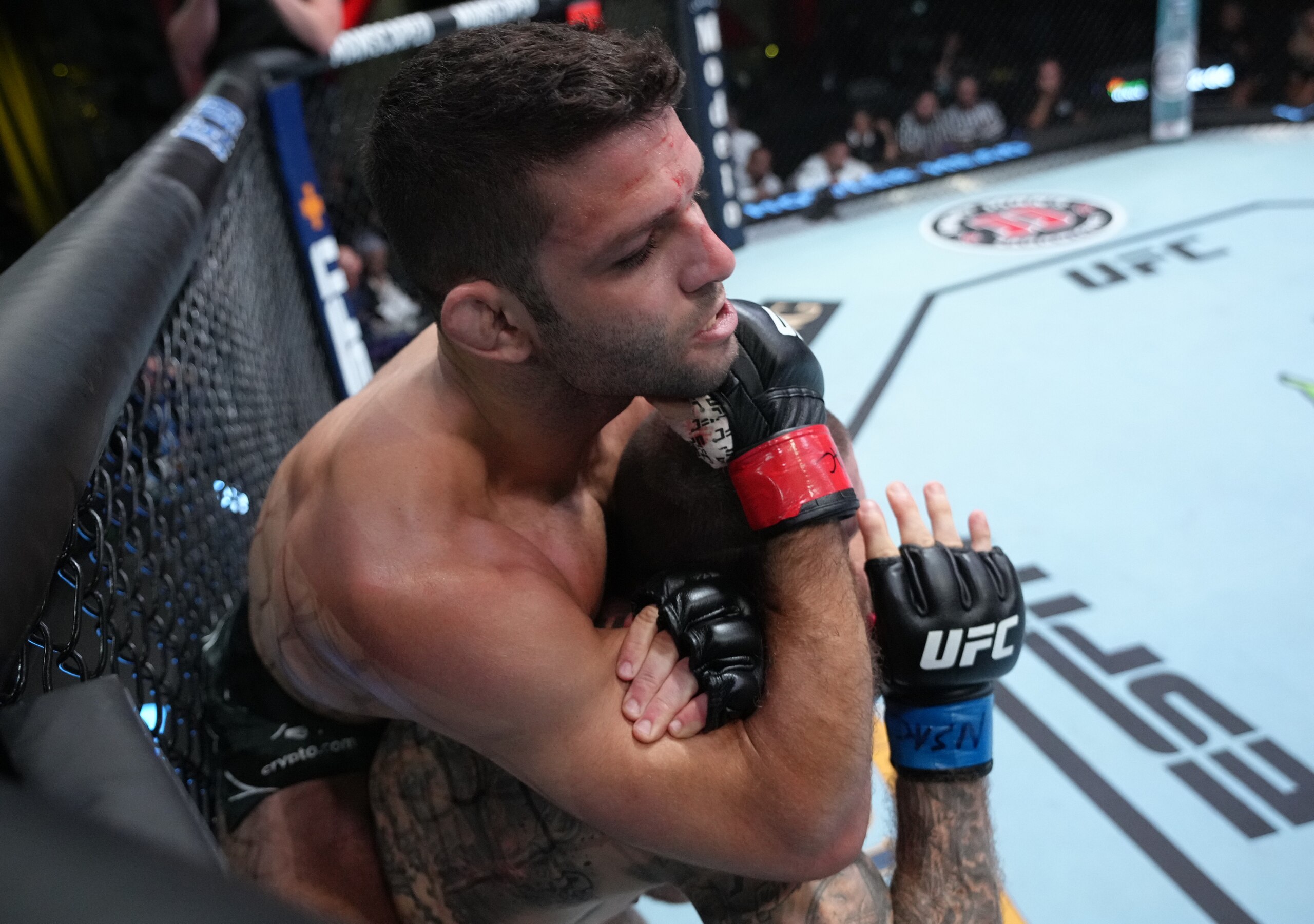 LAS VEGAS, NEVADA - JUNE 25: (L-R) Thiago Moises of Brazil secures a rear choke submission against Christos Giagos in a lightweight fight during the UFC Fight Night event at UFC APEX on June 25, 2022 in Las Vegas, Nevada. (Photo by Jeff Bottari/Zuffa LLC)