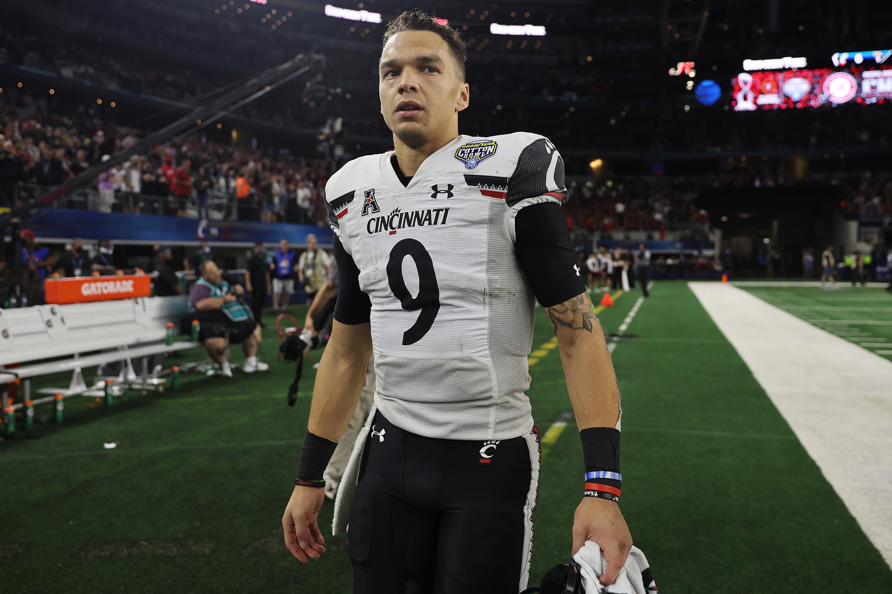ARLINGTON, TEXAS - DECEMBER 31: Desmond Ridder #9 of the Cincinnati Bearcats walks off the field after losing to the Alabama Crimson Tide 27-6 in the Goodyear Cotton Bowl Classic for the College Football Playoff semifinal game at AT&T Stadium on December 31, 2021 in Arlington, Texas. (Photo by Matthew Stockman/Getty Images)