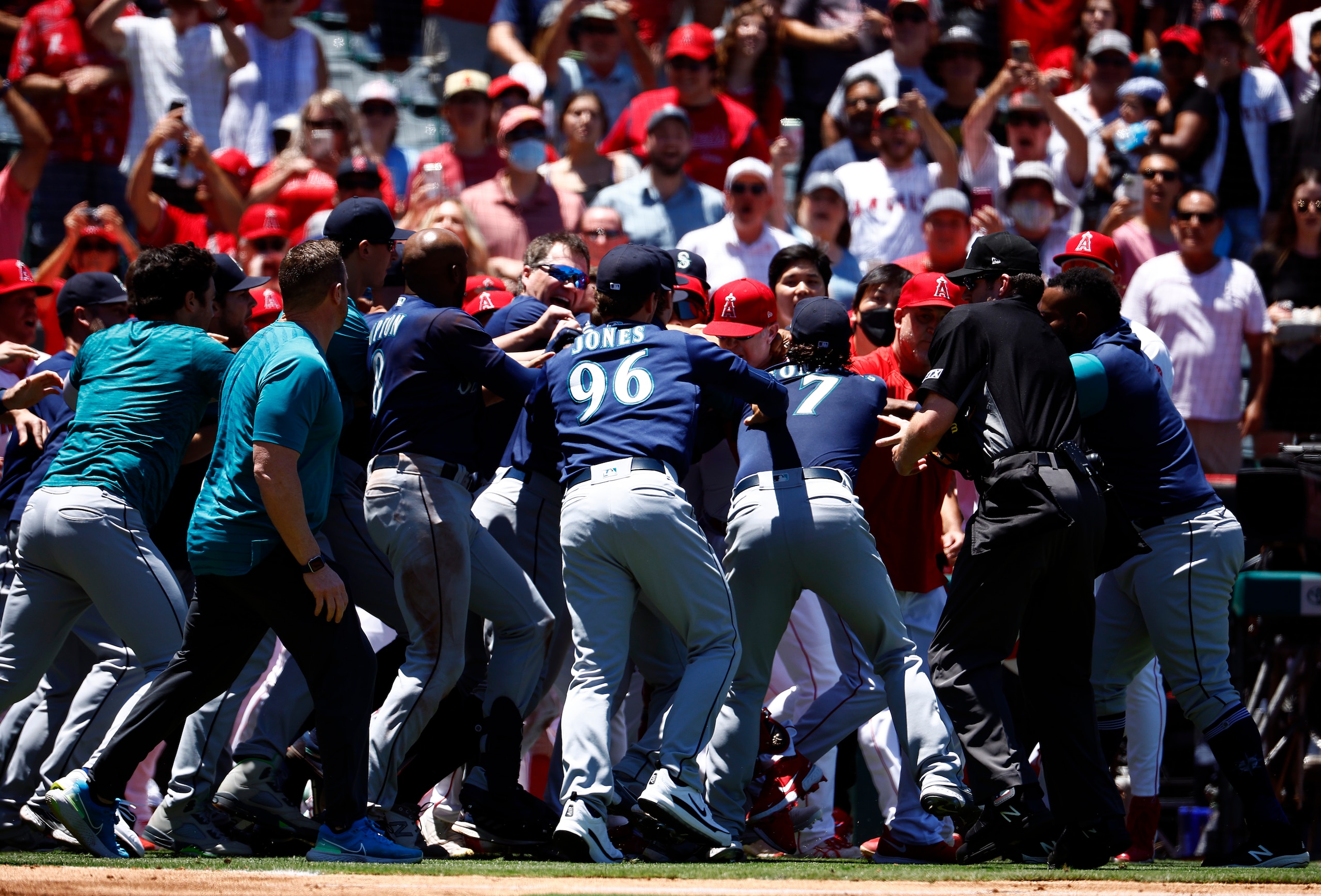 ANAHEIM, CALIFORNIA - JUNE 26:   The Seattle Mariners and the Los Angeles Angels clear the benches after Jesse Winker #27 of the Seattle Mariners charged the Angels dugout after being hit by a pitch in the second inning at Angel Stadium of Anaheim on June 26, 2022 in Anaheim, California. (Photo by Ronald Martinez/Getty Images)