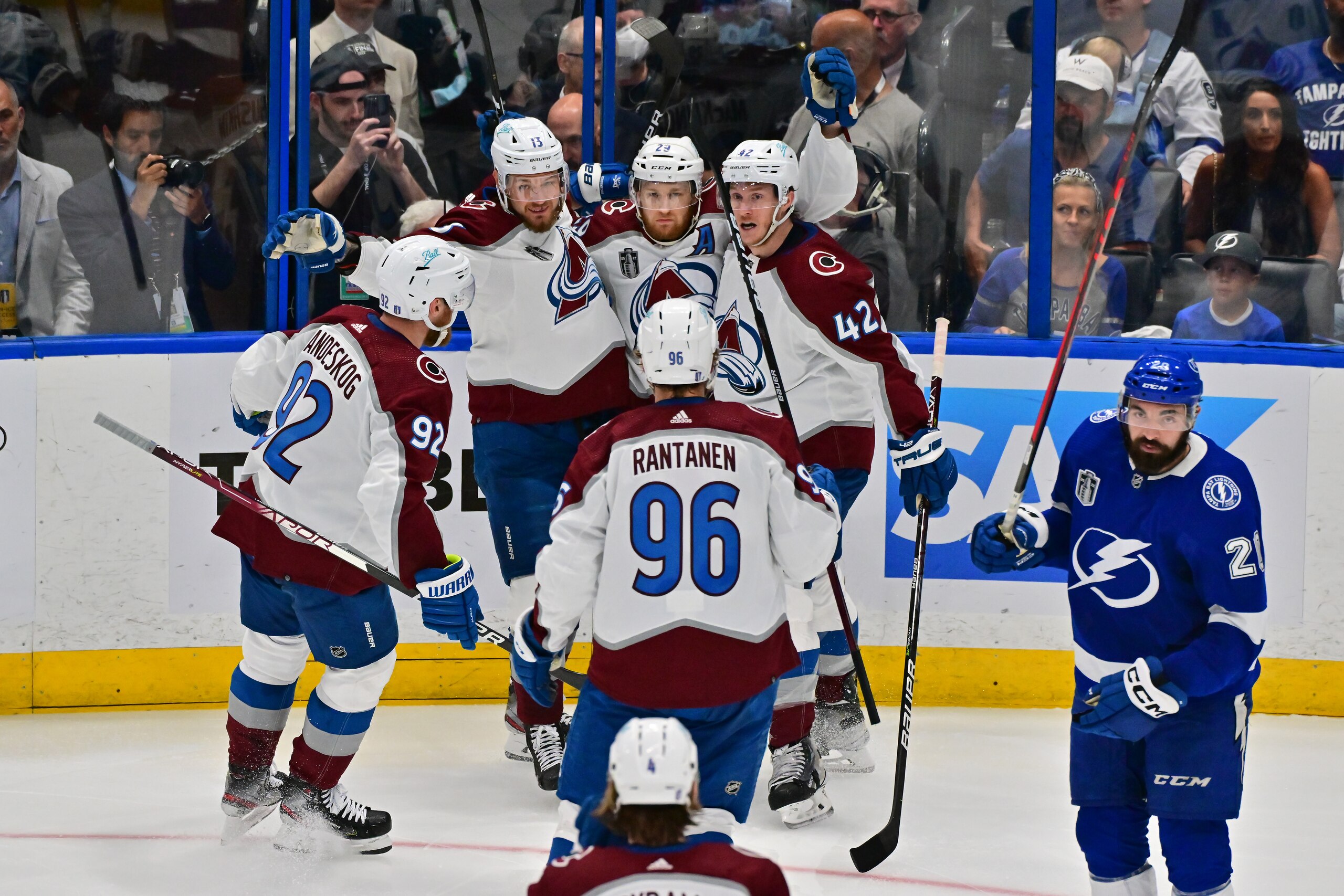TAMPA, FLORIDA - JUNE 26: Nathan MacKinnon #29 of the Colorado Avalanche celebrates scoring a goal with teammates in the second period of Game Six of the 2022 NHL Stanley Cup Final against the Tampa Bay Lightning at Amalie Arena on June 26, 2022 in Tampa, Florida. (Photo by Julio Aguilar/Getty Images)