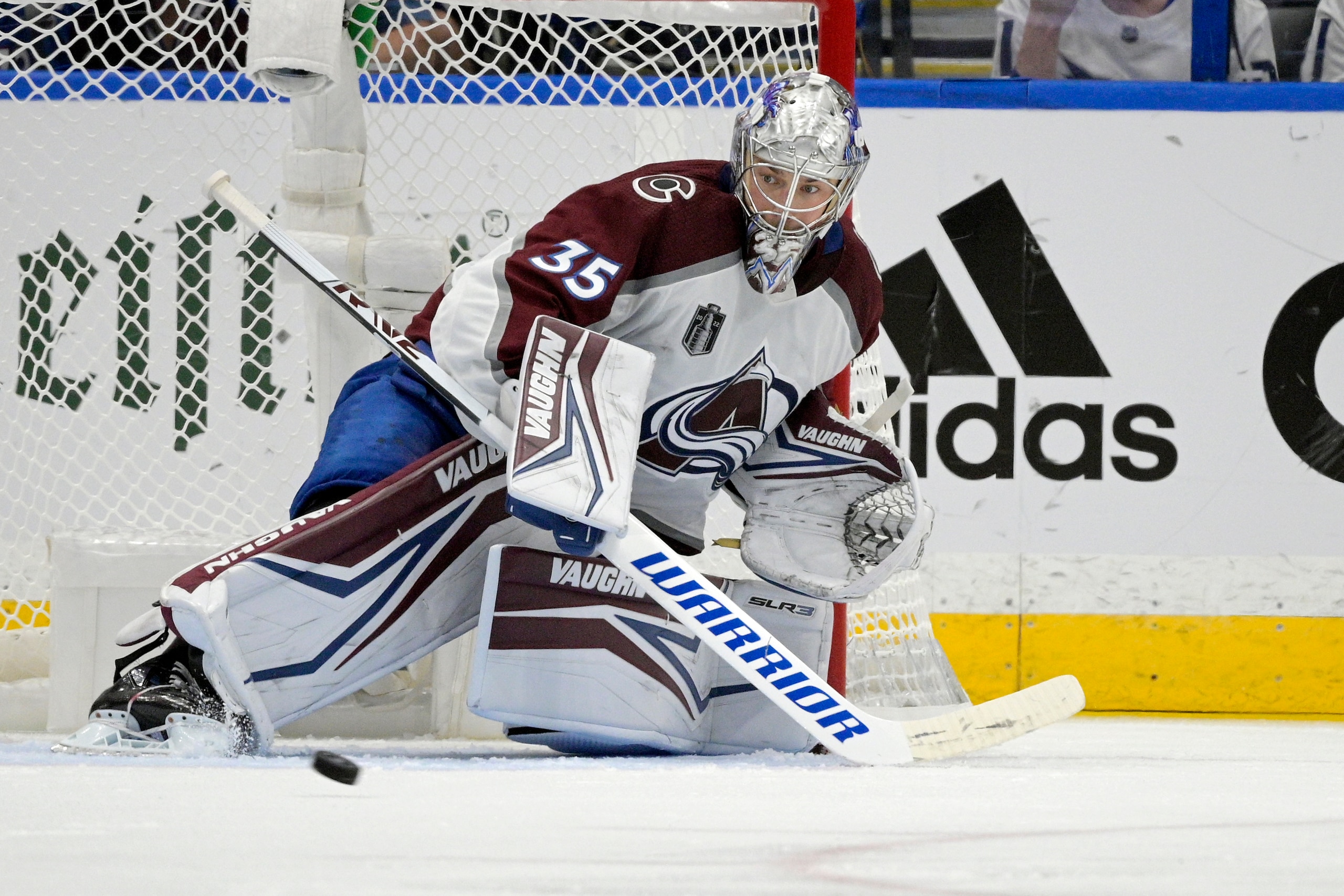 Colorado Avalanche goaltender Darcy Kuemper (35) deflects a puck during the second period of Game 6 of the NHL hockey Stanley Cup Finals against the Tampa Bay Lightning on Sunday, June 26, 2022, in Tampa, Fla. (AP Photo/Phelan Ebenhack)