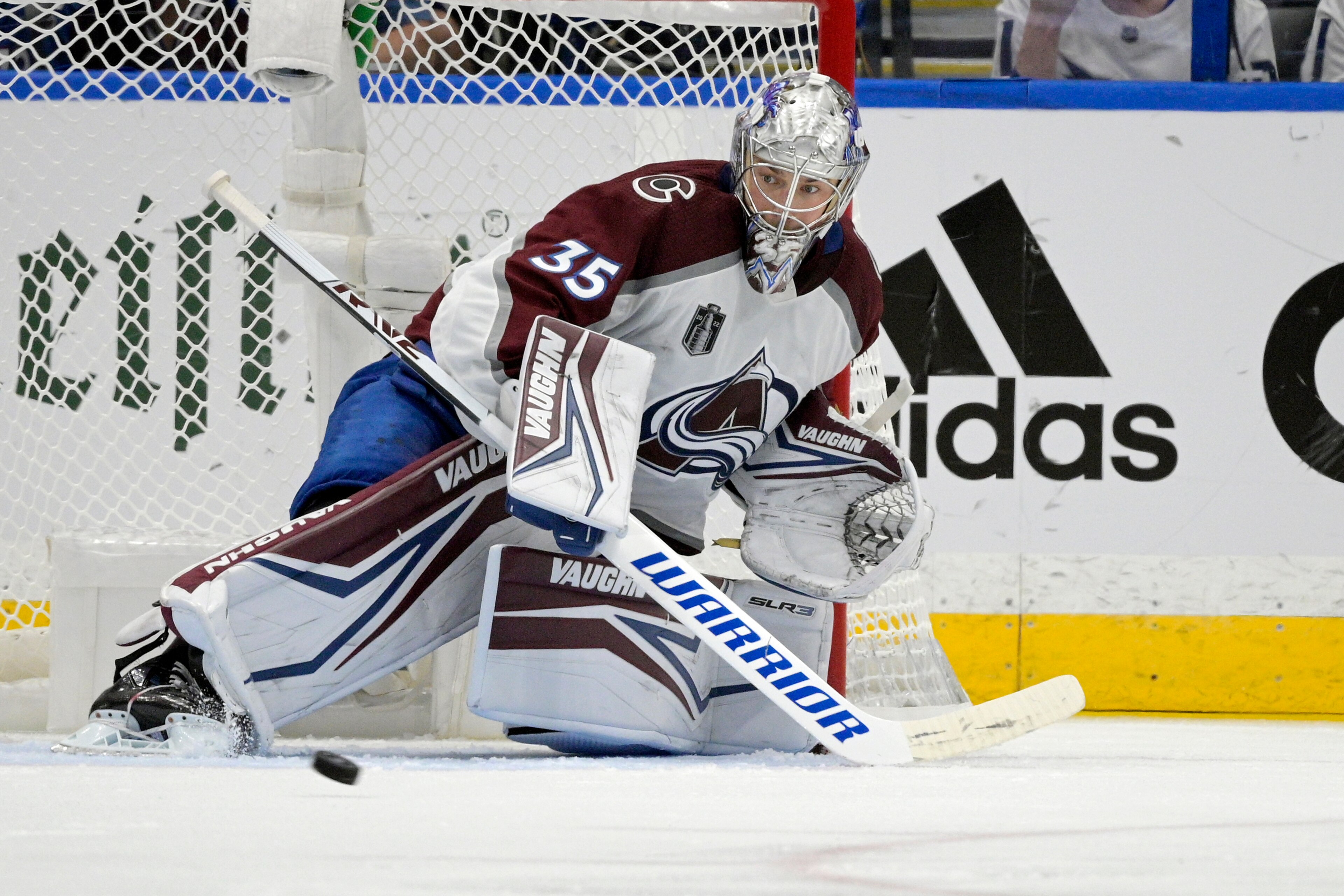 Colorado Avalanche goaltender Darcy Kuemper (35) deflects a puck during the second period of Game 6 of the NHL hockey Stanley Cup Finals against the Tampa Bay Lightning on Sunday, June 26, 2022, in Tampa, Fla. (AP Photo/Phelan Ebenhack)
