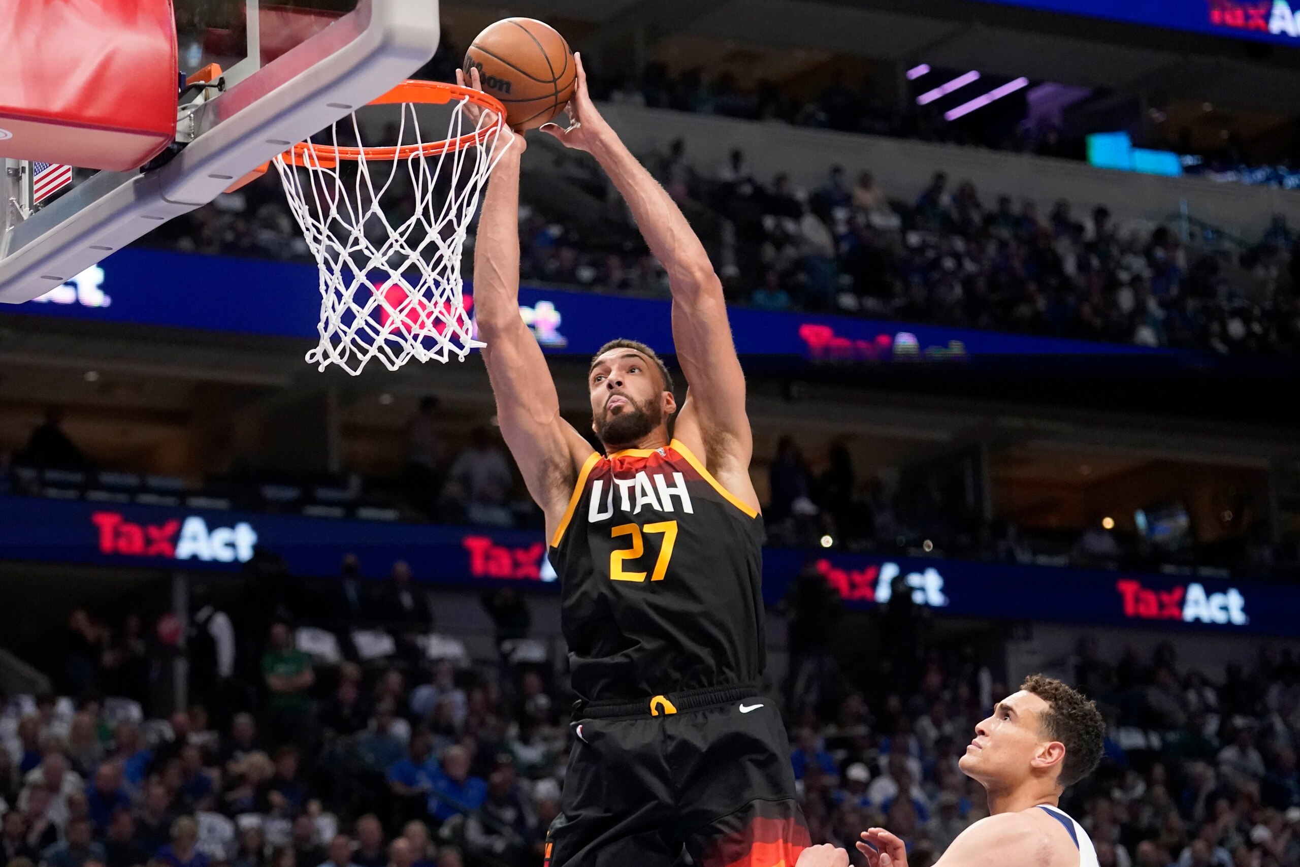 Utah Jazz center Rudy Gobert (27) goes up for a shot-attempt after getting past Dallas Mavericks center Dwight Powell, right, in the first half of Game 2 of an NBA basketball first-round playoff series, Monday, April 18, 2022, in Dallas. (AP Photo/Tony Gutierrez)