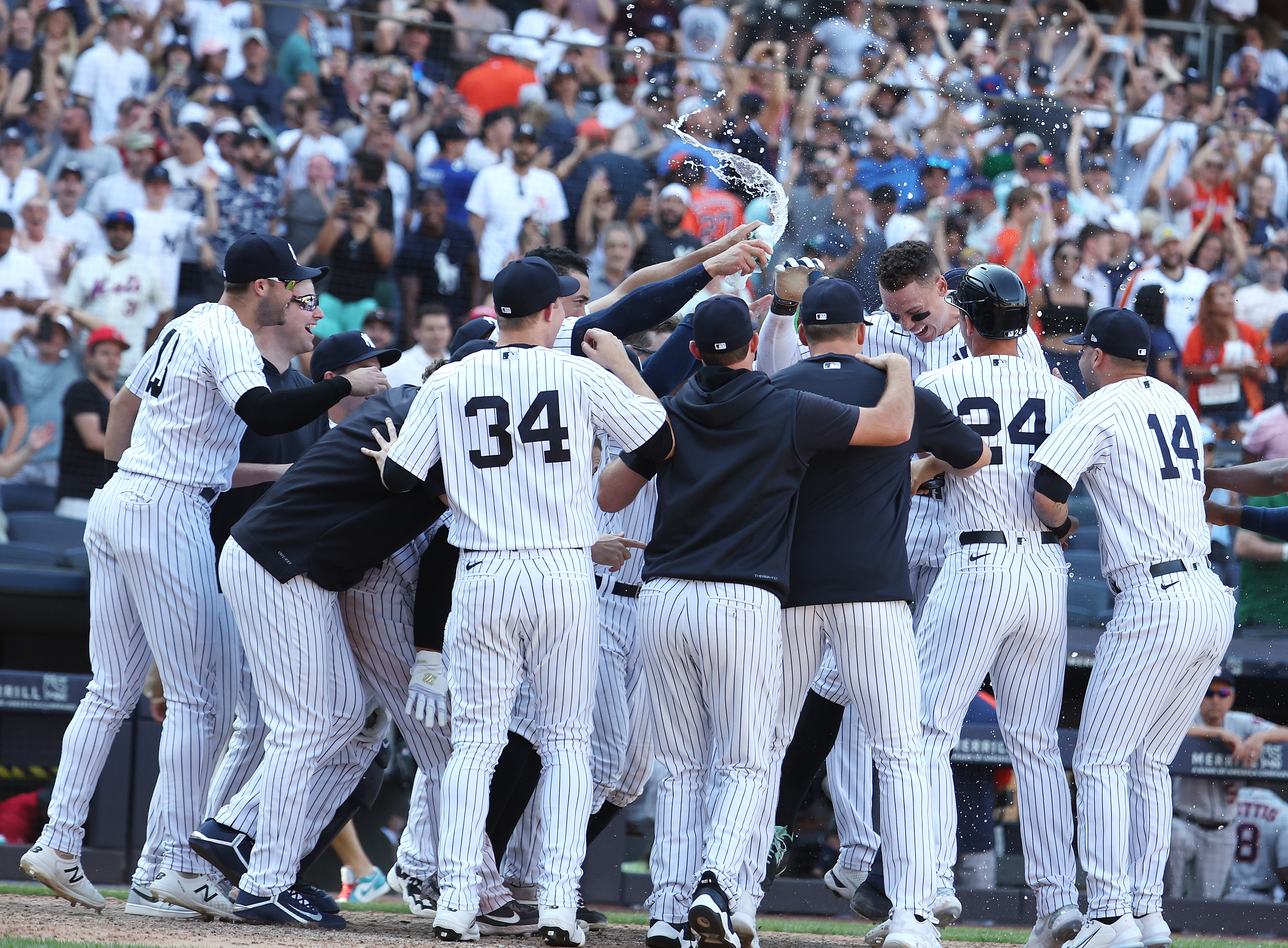 NEW YORK, NEW YORK - JUNE 26:  Aaron Judge #99 of the New York Yankees is greeted by his team after hitting a walk off tenth inning three run home run to win the game 6-3 against the Houston Astros during their game at Yankee Stadium on June 26, 2022 in New York City. (Photo by Al Bello/Getty Images)