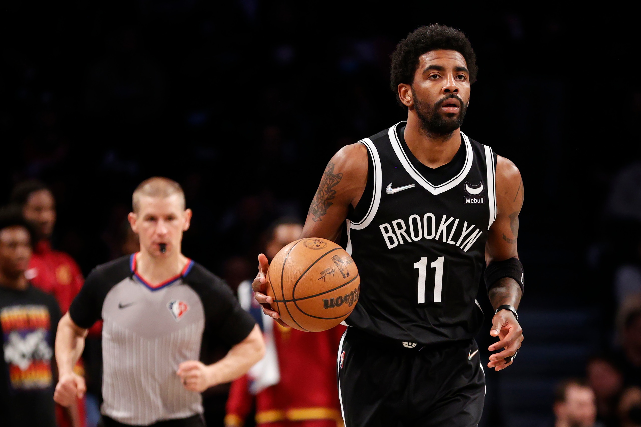 NEW YORK, NEW YORK - APRIL 12: Kyrie Irving #11 of the Brooklyn Nets dribbles during the first half of the Eastern Conference 2022 Play-In Tournament against the Cleveland Cavaliers at Barclays Center on April 12, 2022 in the Brooklyn borough of New York City. NOTE TO USER: User expressly acknowledges and agrees that, by downloading and or using this photograph, User is consenting to the terms and conditions of the Getty Images License Agreement. (Photo by Sarah Stier/Getty Images)