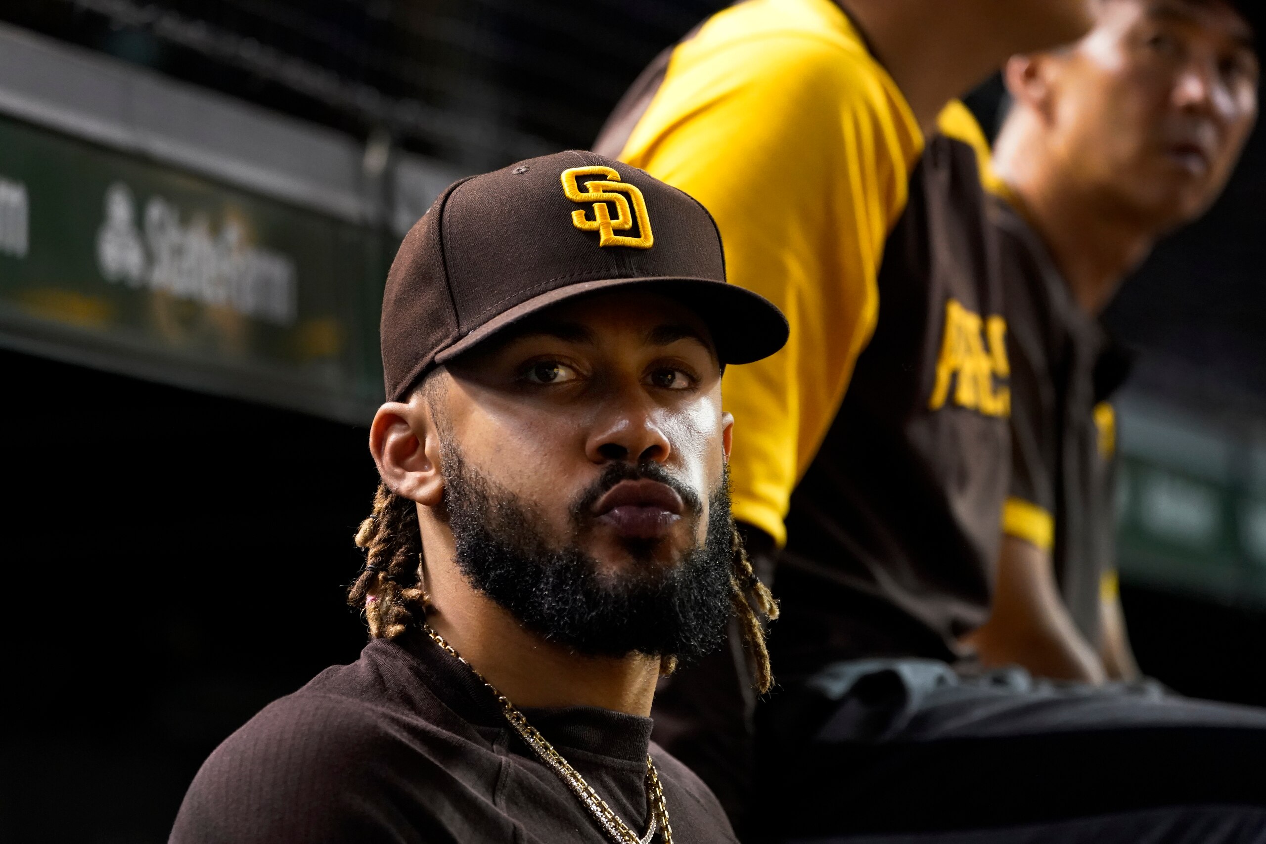 San Diego Padres' Fernando Tatis Jr., looks out of the dugout during the fifth inning of the team's baseball game against the Chicago Cubs on Wednesday, June 15, 2022, in Chicago. (AP Photo/Charles Rex Arbogast)