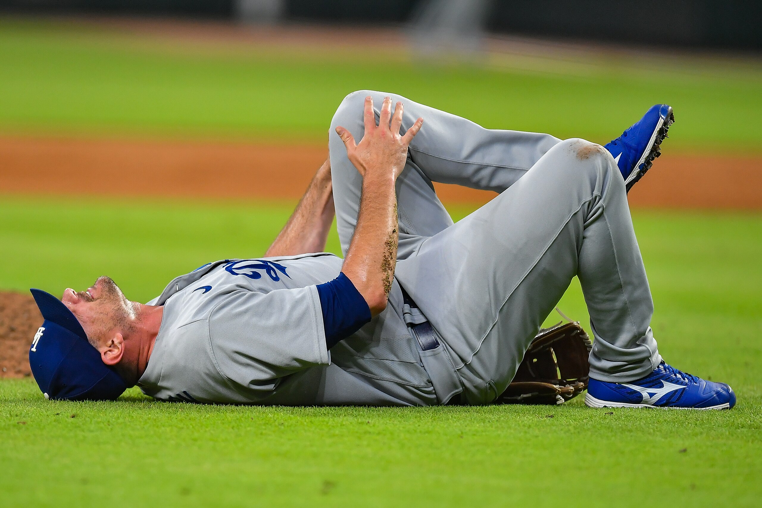 ATLANTA, GA  JUNE 24:  Los Angeles relief pitcher Daniel Hudson (41) grabs his left knee after falling to the ground during the MLB game between the Los Angeles Dodgers and the Atlanta Braves on June 24th, 2022 at Truist Park in Atlanta, GA. (Photo by Rich von Biberstein/Icon Sportswire via Getty Images)