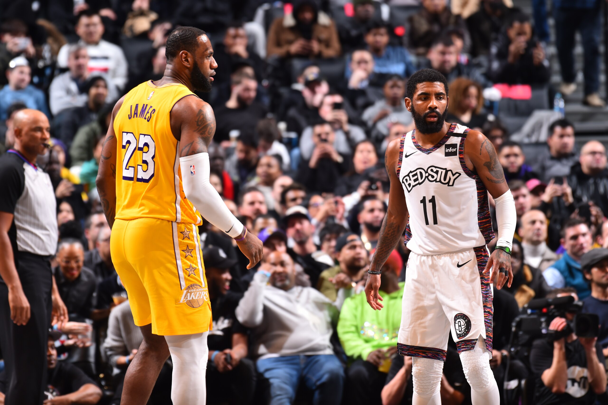 BROOKLYN, NY - JANUARY 23: LeBron James #23 of the Los Angeles Lakers and Kyrie Irving #11 of the Brooklyn Nets look on during a game on January 23, 2020 at Barclays Center in Brooklyn, New York. NOTE TO USER: User expressly acknowledges and agrees that, by downloading and or using this Photograph, user is consenting to the terms and conditions of the Getty Images License Agreement. Mandatory Copyright Notice: Copyright 2020 NBAE (Photo by Jesse D. Garrabrant/NBAE via Getty Images)