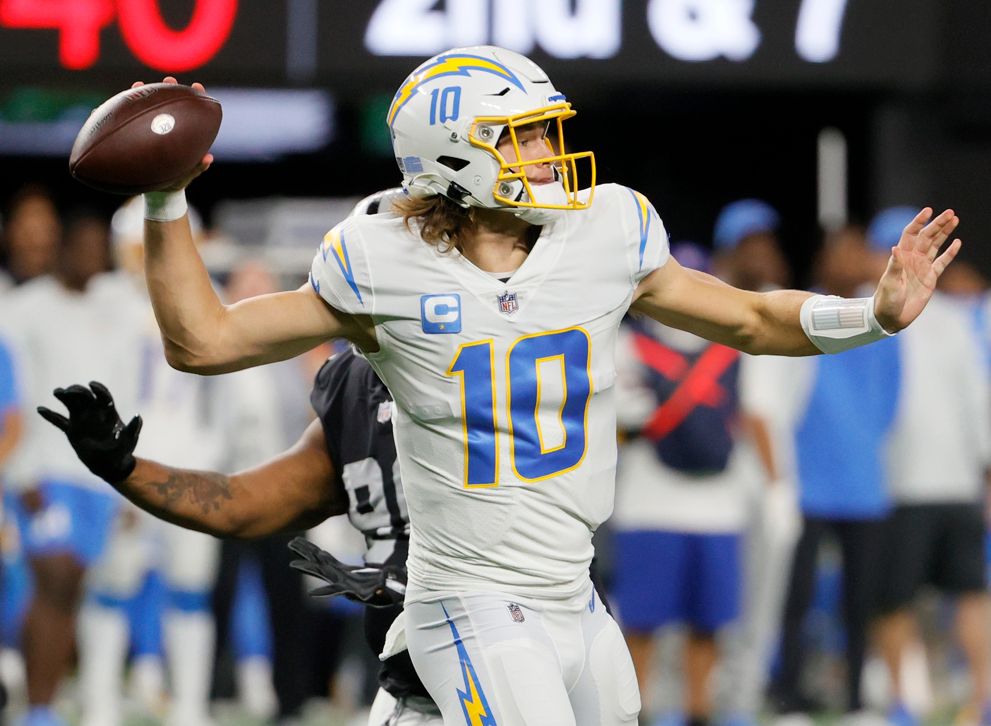 LAS VEGAS, NEVADA - JANUARY 09:  Quarterback Justin Herbert #10 of the Los Angeles Chargers throws against the Las Vegas Raiders during their game at Allegiant Stadium on January 9, 2022 in Las Vegas, Nevada. The Raiders defeated the Chargers 35-32 in overtime.  (Photo by Ethan Miller/Getty Images)