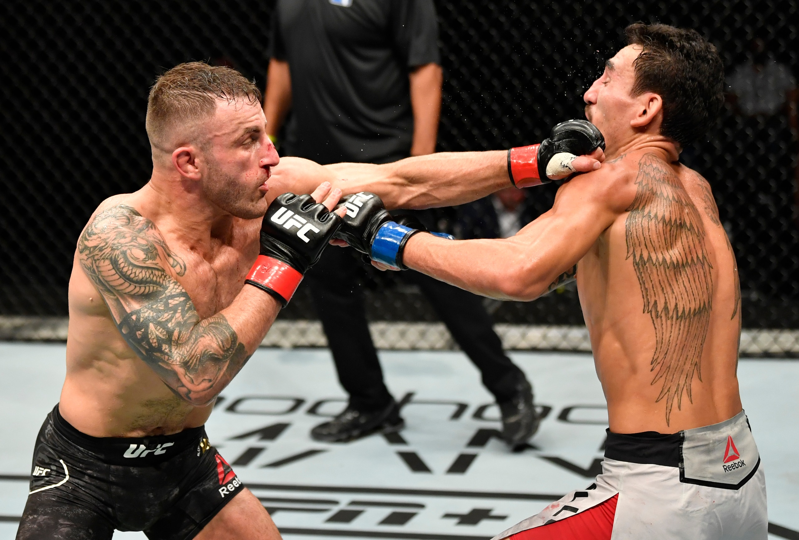 ABU DHABI, UNITED ARAB EMIRATES - JULY 12: In this handout image provided by UFC, (L-R) Alexander Volkanovski of Australia punches Max Holloway in their UFC featherweight championship fight during the UFC 251 event at Flash Forum on UFC Fight Island on July 12, 2020 on Yas Island, Abu Dhabi, United Arab Emirates. (Photo by Jeff Bottari/Zuffa LLC via Getty Images)