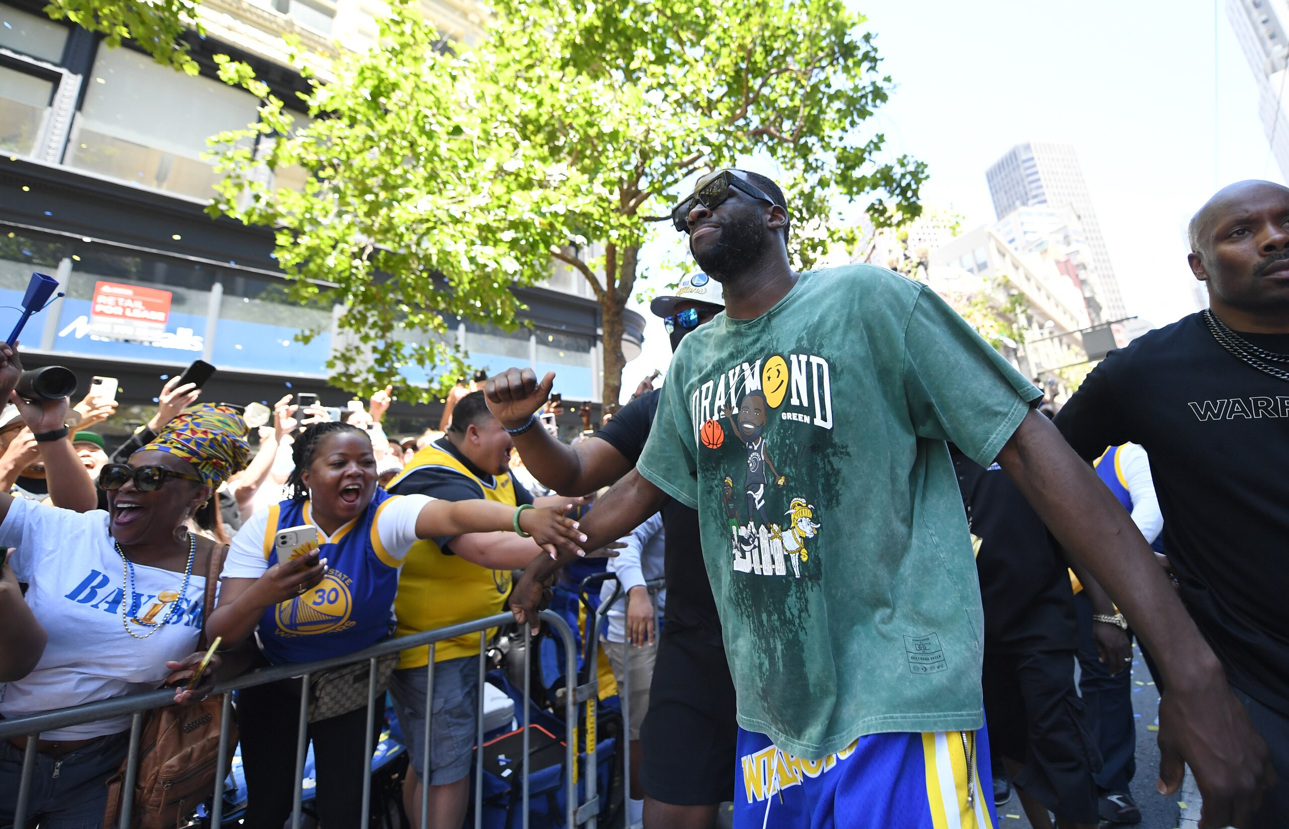 SAN FRANCISCO, CALIFORNIA - JUNE 20:  Draymond Green #23 of the Golden State Warriors high fives fans in the crowd during their Victory Parade & Rally on June 20, 2022 in San Francisco, California. The Golden State Warriors beat the Boston Celtics 4-2 to win the 2022 NBA Finals. NOTE TO USER: User expressly acknowledges and agrees that, by downloading and or using this photograph, user is consenting to the terms and conditions of Getty Images License Agreement. (Photo by Michael Urakami/Getty Images)