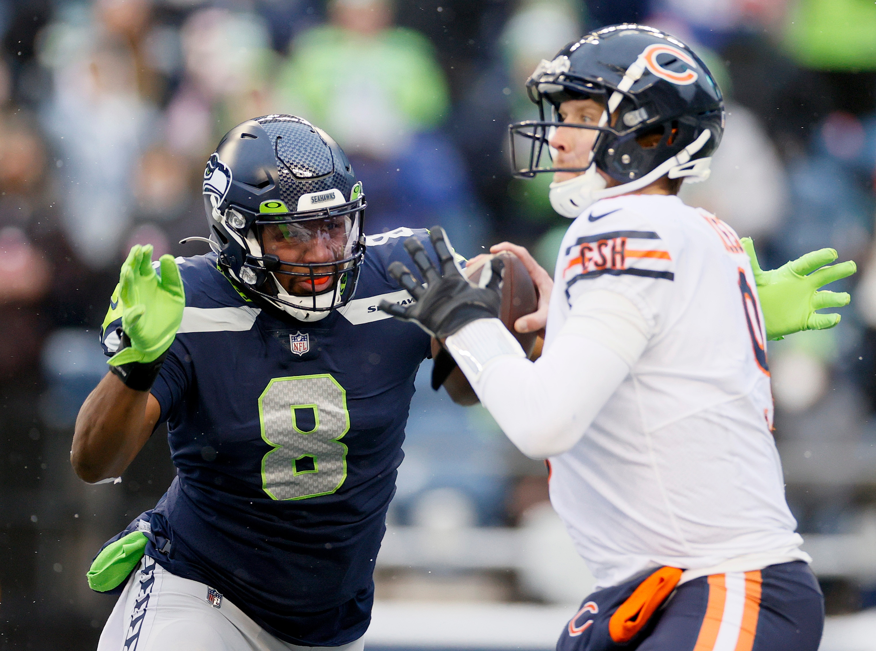 SEATTLE, WASHINGTON - DECEMBER 26: Nick Foles #9 of the Chicago Bears is pressured by Carlos Dunlap #8 of the Seattle Seahawks as he attempts to throw the ball during the third quarter at Lumen Field on December 26, 2021 in Seattle, Washington. (Photo by Steph Chambers/Getty Images)