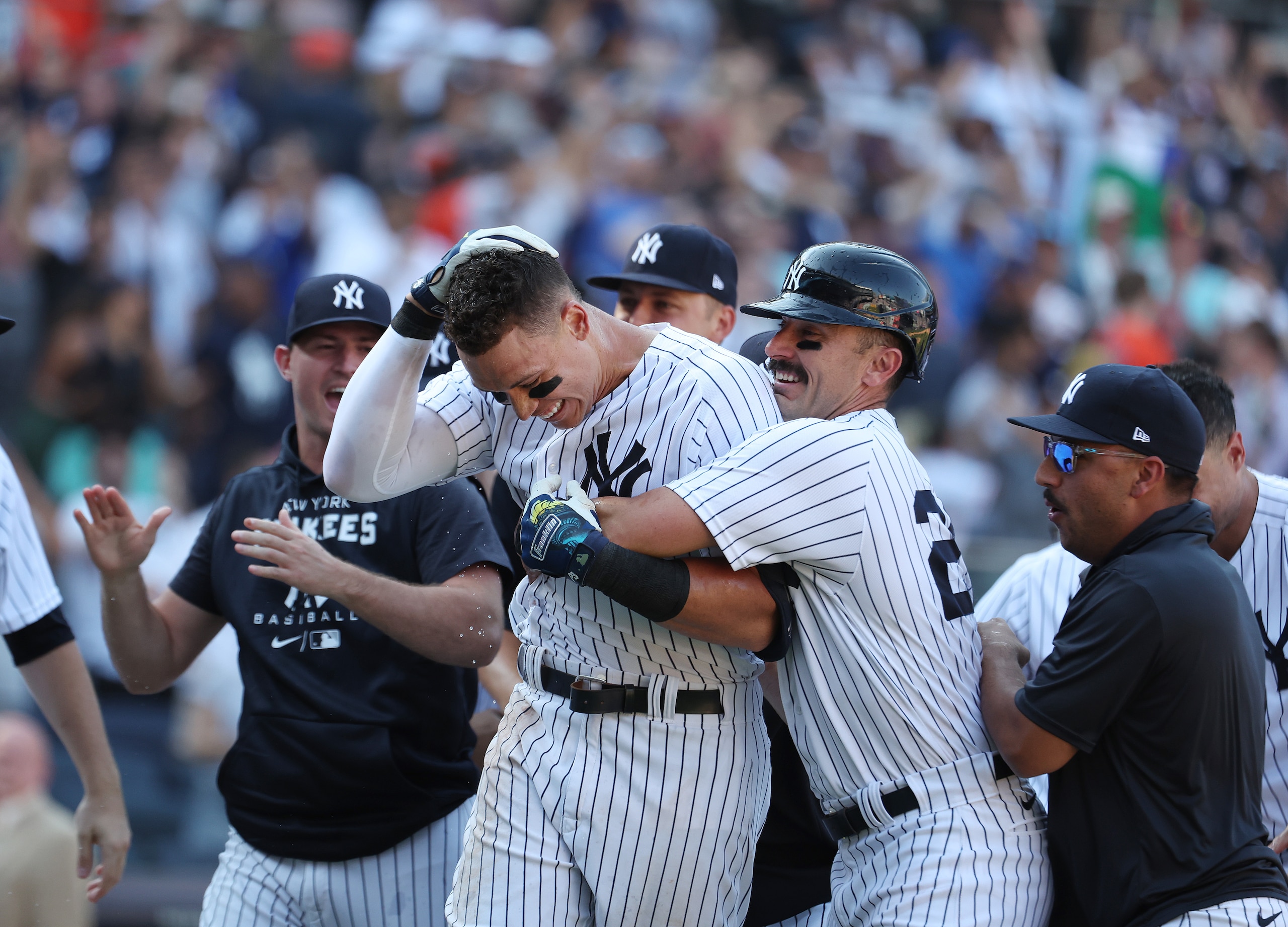 NEW YORK, NEW YORK - JUNE 26:  Aaron Judge #99 of the New York Yankees is greeted by his team after hitting a walk off tenth inning three run home run to win the game 6-3 against the Houston Astros during their game at Yankee Stadium on June 26, 2022 in New York City. (Photo by Al Bello/Getty Images)