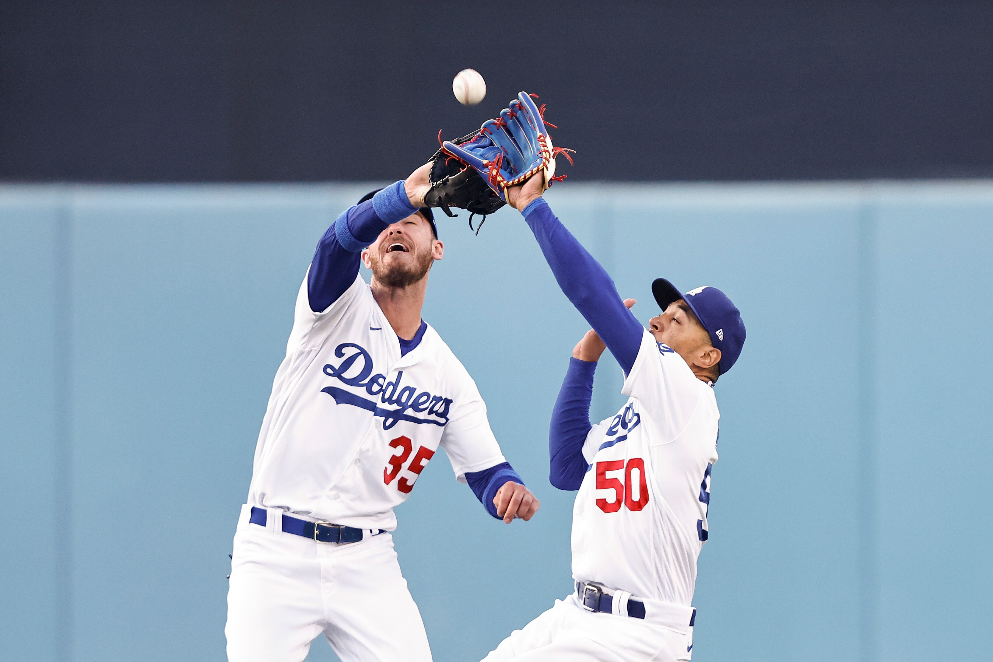 LOS ANGELES, CALIFORNIA - JUNE 15: Cody Bellinger #35 and Mookie Betts #50 of the Los Angeles Dodgers collide for a fielding error against the Los Angeles Angels during the first inning at Dodger Stadium on June 15, 2022 in Los Angeles, California. (Photo by Michael Owens/Getty Images)
