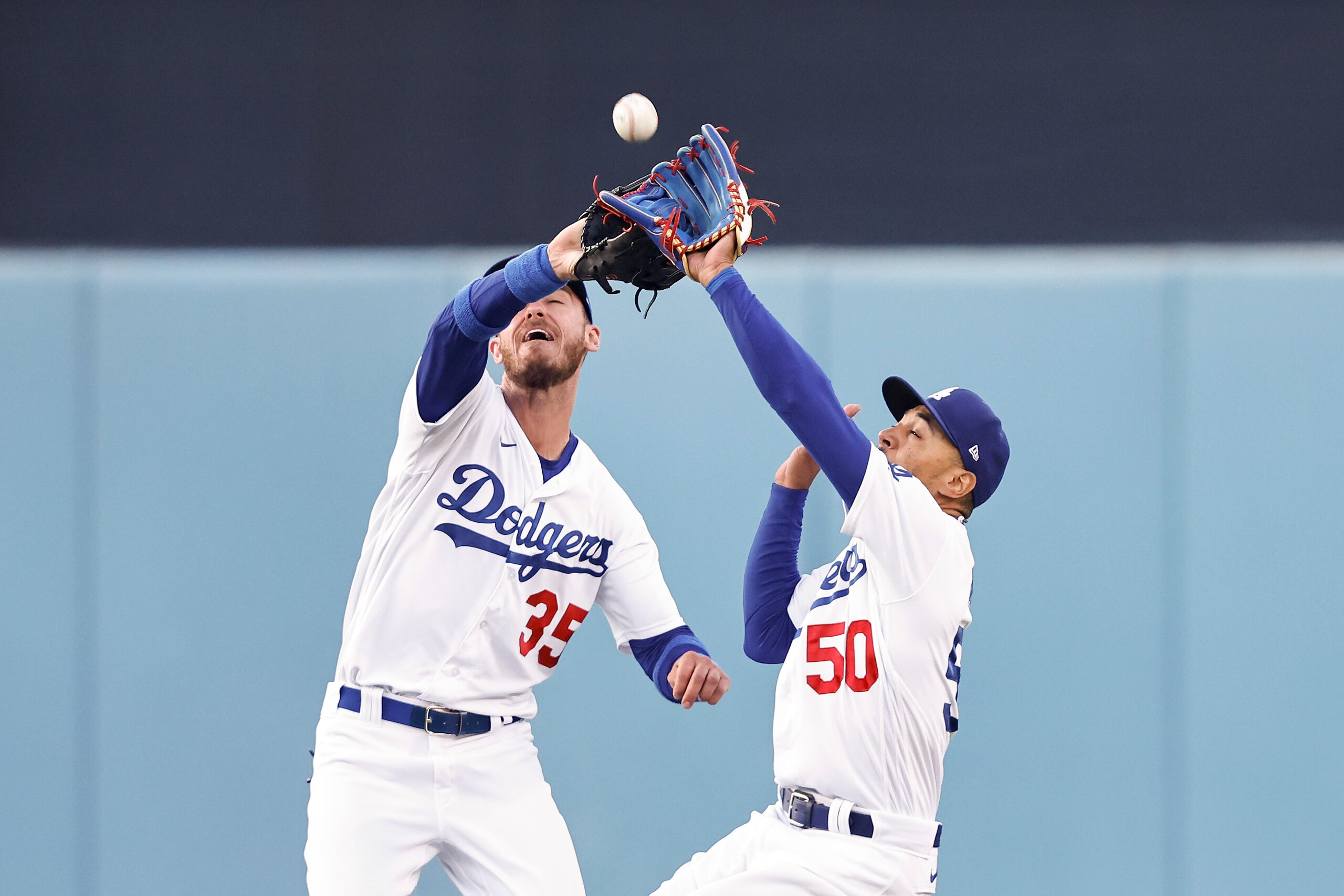 LOS ANGELES, CALIFORNIA - JUNE 15: Cody Bellinger #35 and Mookie Betts #50 of the Los Angeles Dodgers collide for a fielding error against the Los Angeles Angels during the first inning at Dodger Stadium on June 15, 2022 in Los Angeles, California. (Photo by Michael Owens/Getty Images)