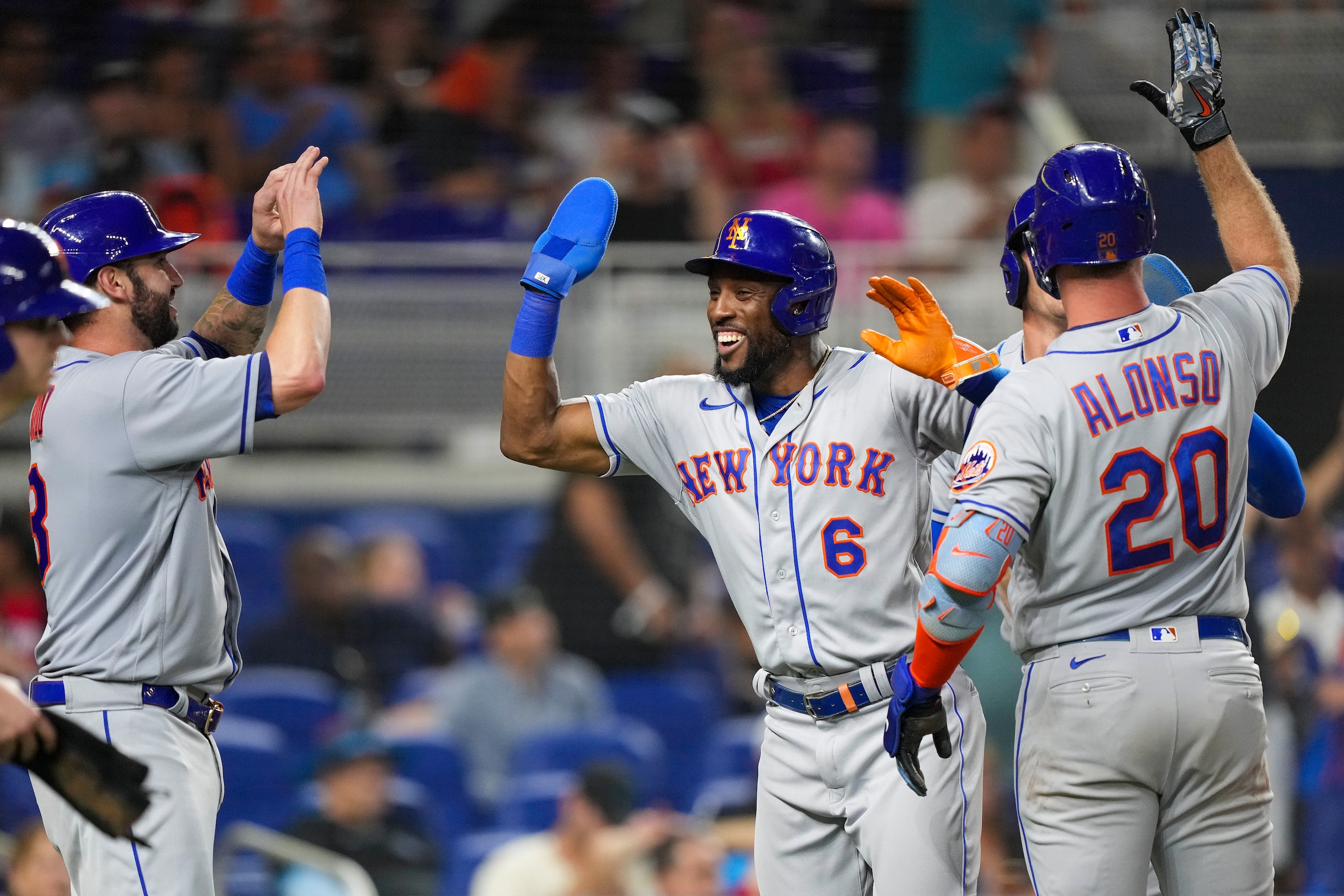MIAMI, FLORIDA - JUNE 24: Starling Marte #6 of the New York Mets is congratulated by Tomas Nido #3 and Pete Alonso #20  after scoring in the sixth inning against the Miami Marlins at loanDepot park on June 24, 2022 in Miami, Florida. (Photo by Eric Espada/Getty Images)