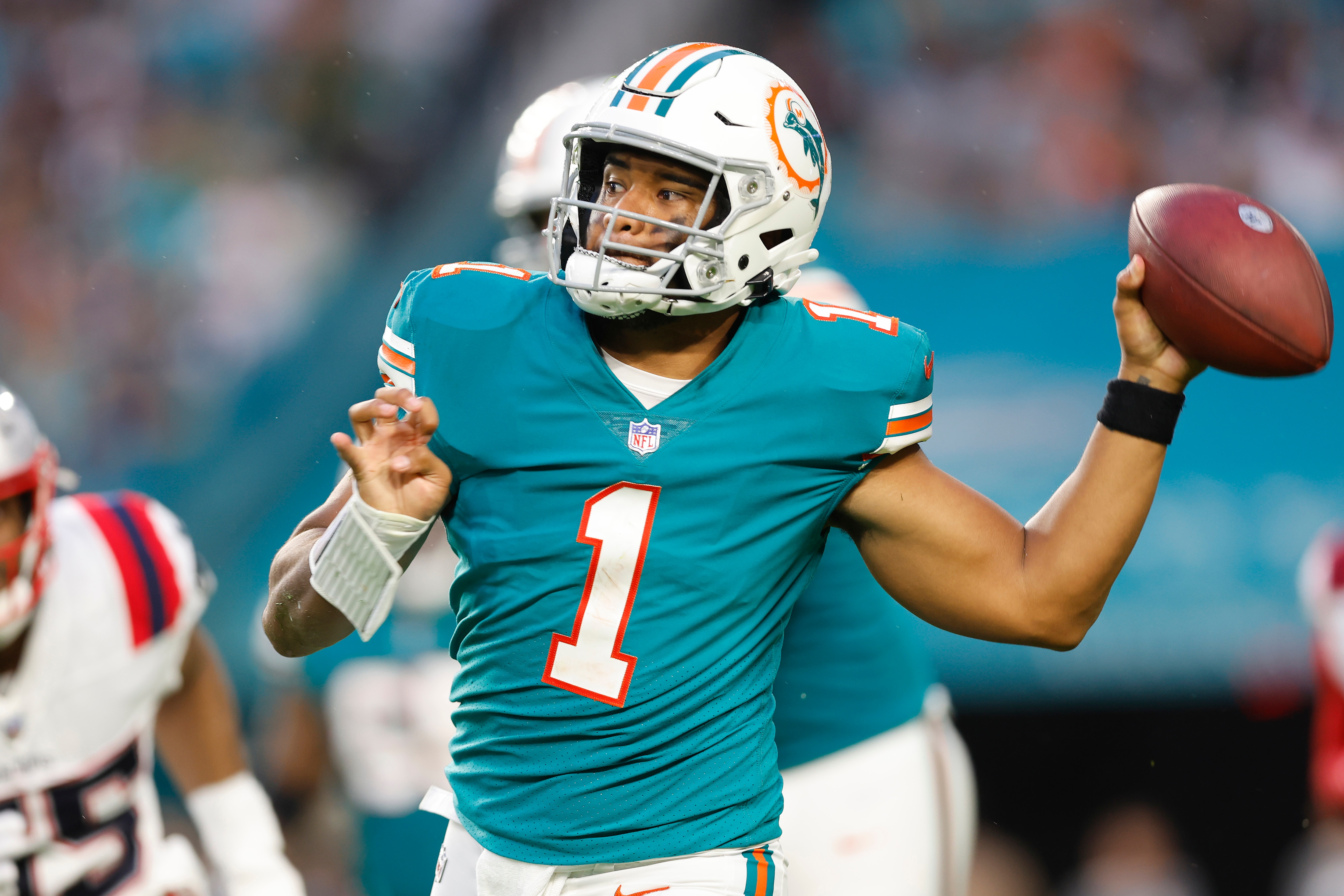 MIAMI GARDENS, FLORIDA - JANUARY 09: Tua Tagovailoa #1 of the Miami Dolphins looks to pass against the New England Patriots at Hard Rock Stadium on January 09, 2022 in Miami Gardens, Florida. (Photo by Michael Reaves/Getty Images)