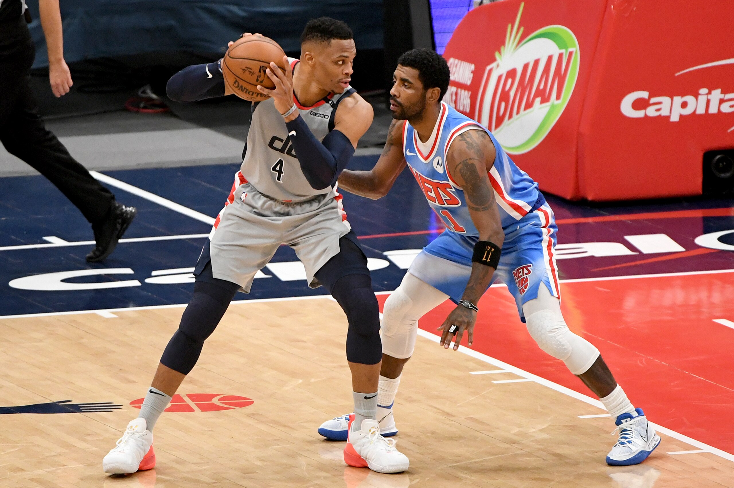 WASHINGTON, DC - JANUARY 31: Russell Westbrook #4 of the Washington Wizards looks to pass as Kyrie Irving #11 of the Brooklyn Nets defends during the first half at Capital One Arena on January 31, 2021 in Washington, DC. NOTE TO USER: User expressly acknowledges and agrees that, by downloading and or using this photograph, User is consenting to the terms and conditions of the Getty Images License Agreement. (Photo by Will Newton/Getty Images)