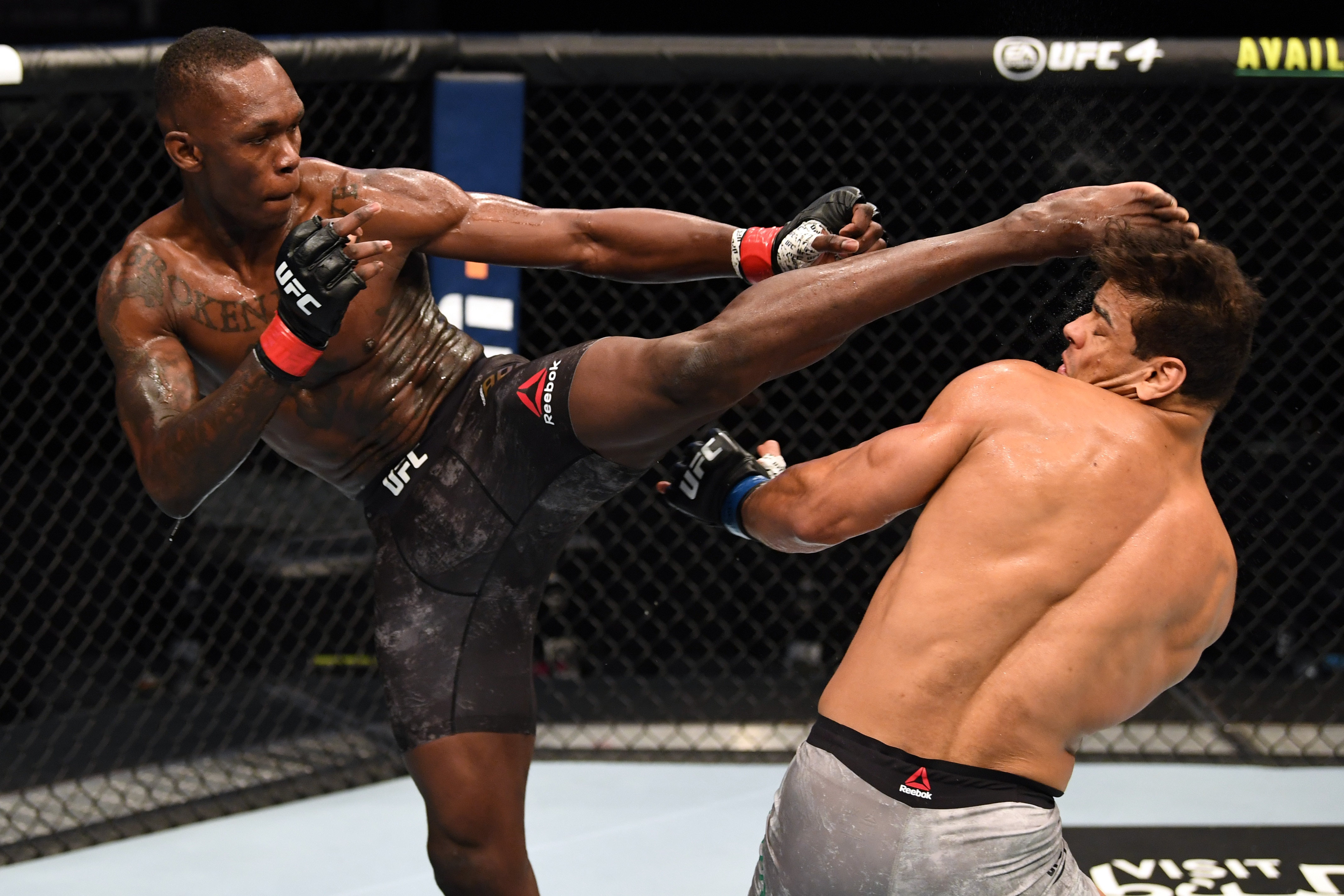ABU DHABI, UNITED ARAB EMIRATES - SEPTEMBER 27:  (L-R) Israel Adesanya of Nigeria kicks the head of Paulo Costa of Brazil in their middleweight championship bout during UFC 253 inside Flash Forum on UFC Fight Island on September 27, 2020 in Abu Dhabi, United Arab Emirates. (Photo by Josh Hedges/Zuffa LLC)