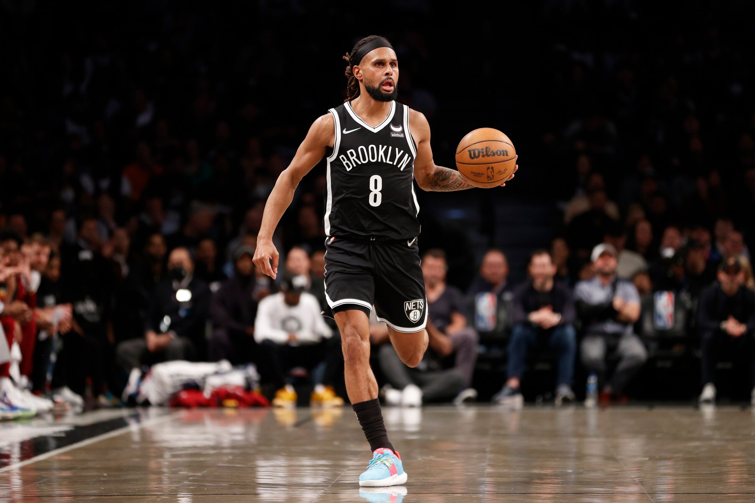 NEW YORK, NEW YORK - APRIL 12: Patty Mills #8 of the Brooklyn Nets dribbles during the first half of the Eastern Conference 2022 Play-In Tournament against the Cleveland Cavaliers at Barclays Center on April 12, 2022 in the Brooklyn borough of New York City. NOTE TO USER: User expressly acknowledges and agrees that, by downloading and or using this photograph, User is consenting to the terms and conditions of the Getty Images License Agreement. (Photo by Sarah Stier/Getty Images)