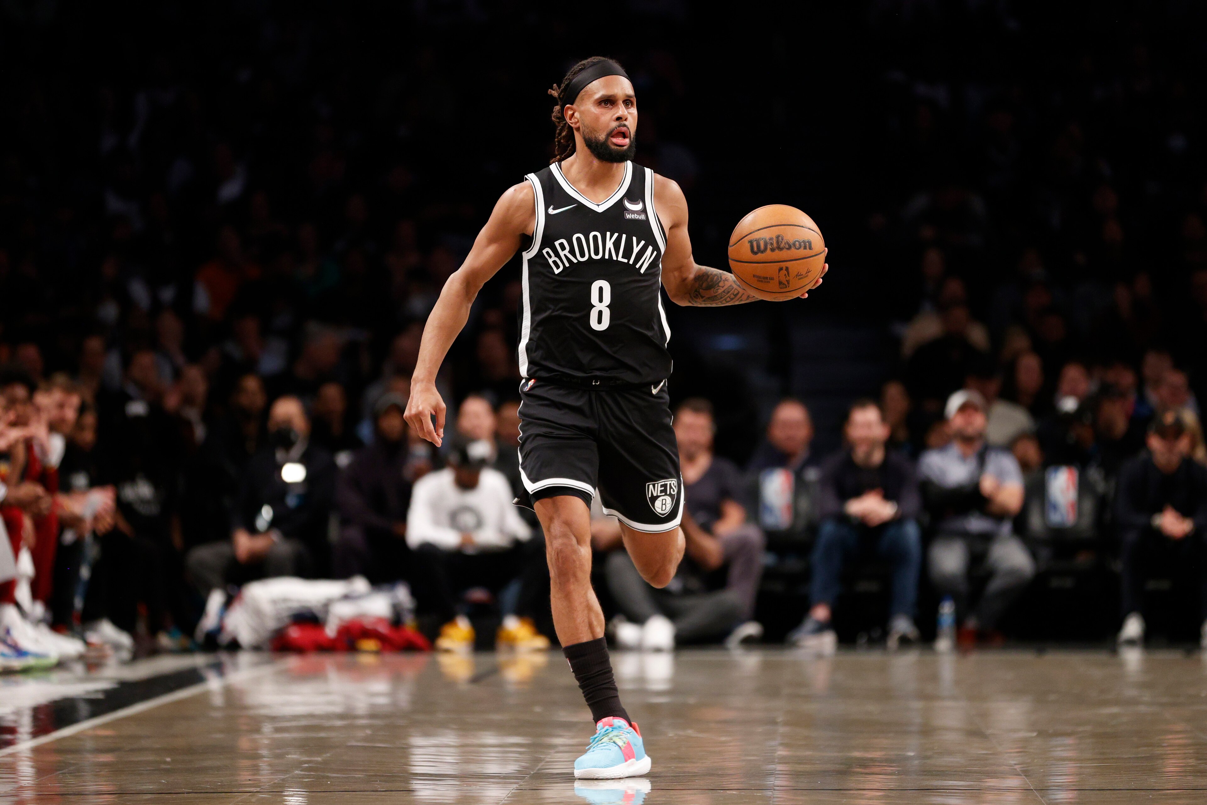 NEW YORK, NEW YORK - APRIL 12: Patty Mills #8 of the Brooklyn Nets dribbles during the first half of the Eastern Conference 2022 Play-In Tournament against the Cleveland Cavaliers at Barclays Center on April 12, 2022 in the Brooklyn borough of New York City. NOTE TO USER: User expressly acknowledges and agrees that, by downloading and or using this photograph, User is consenting to the terms and conditions of the Getty Images License Agreement. (Photo by Sarah Stier/Getty Images)