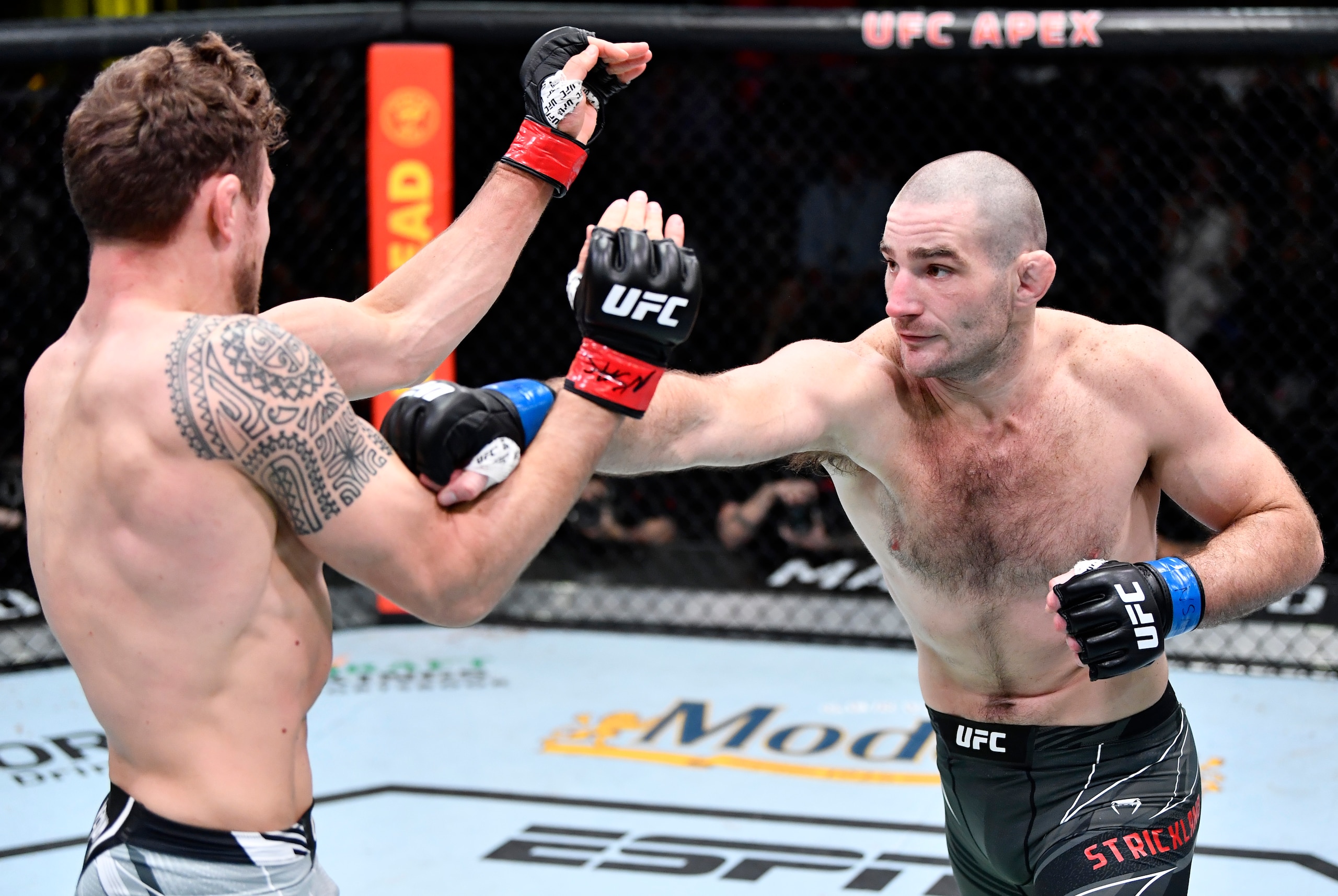 LAS VEGAS, NEVADA - FEBRUARY 05: (R-L) Sean Strickland punches Jack Hermansson of Sweden in their middleweight fight during the UFC Fight Night event at UFC APEX on February 05, 2022 in Las Vegas, Nevada. (Photo by Chris Unger/Zuffa LLC)