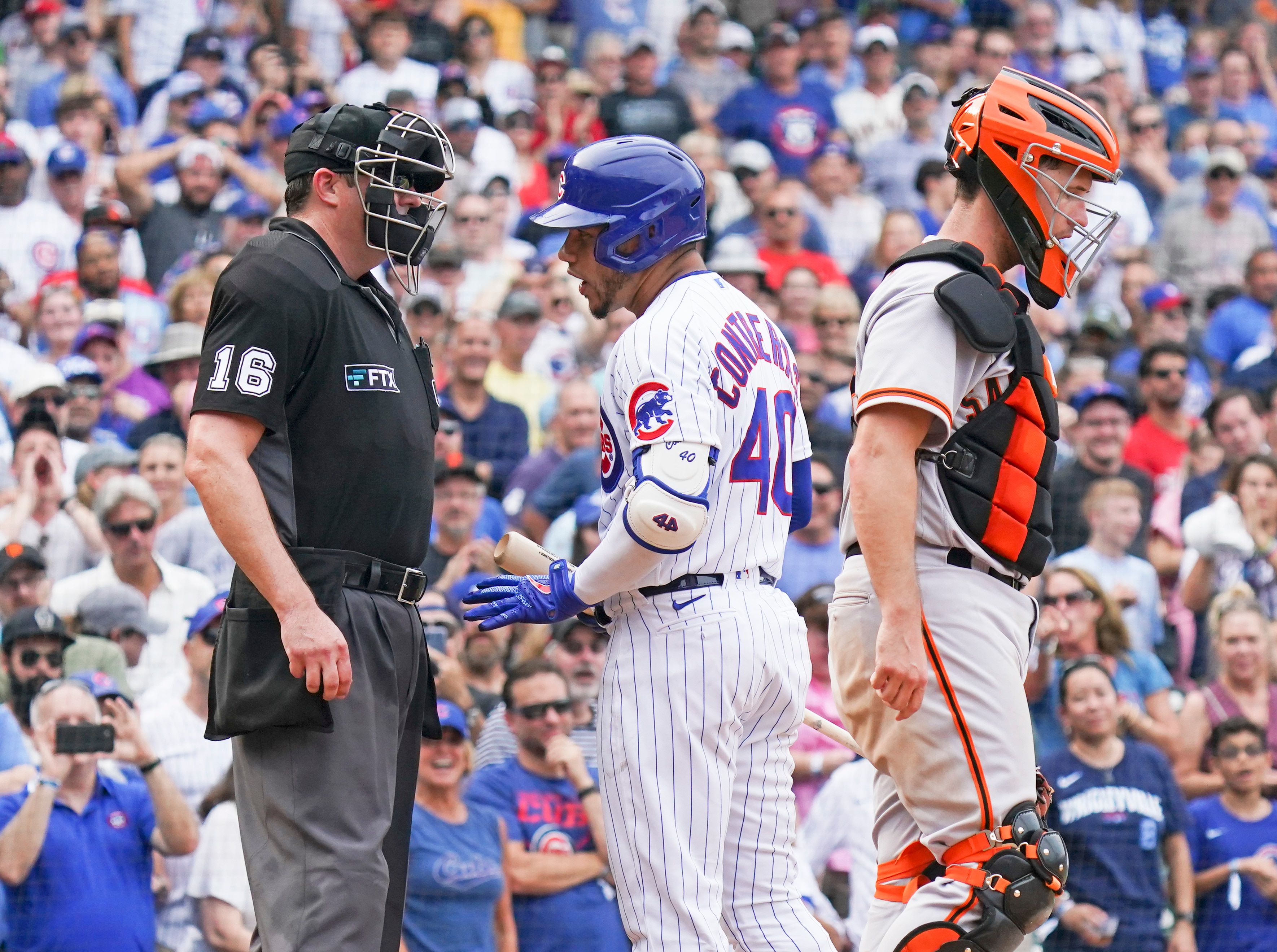 CHICAGO, ILLINOIS - SEPTEMBER 12: Willson Contreras #40 of the Chicago Cubs has words with home plate umpire Lance Barrett #16 after striking out during the seventh inning of a game against the San Francisco Giants at Wrigley Field on September 12, 2021 in Chicago, Illinois. (Photo by Nuccio DiNuzzo/Getty Images)