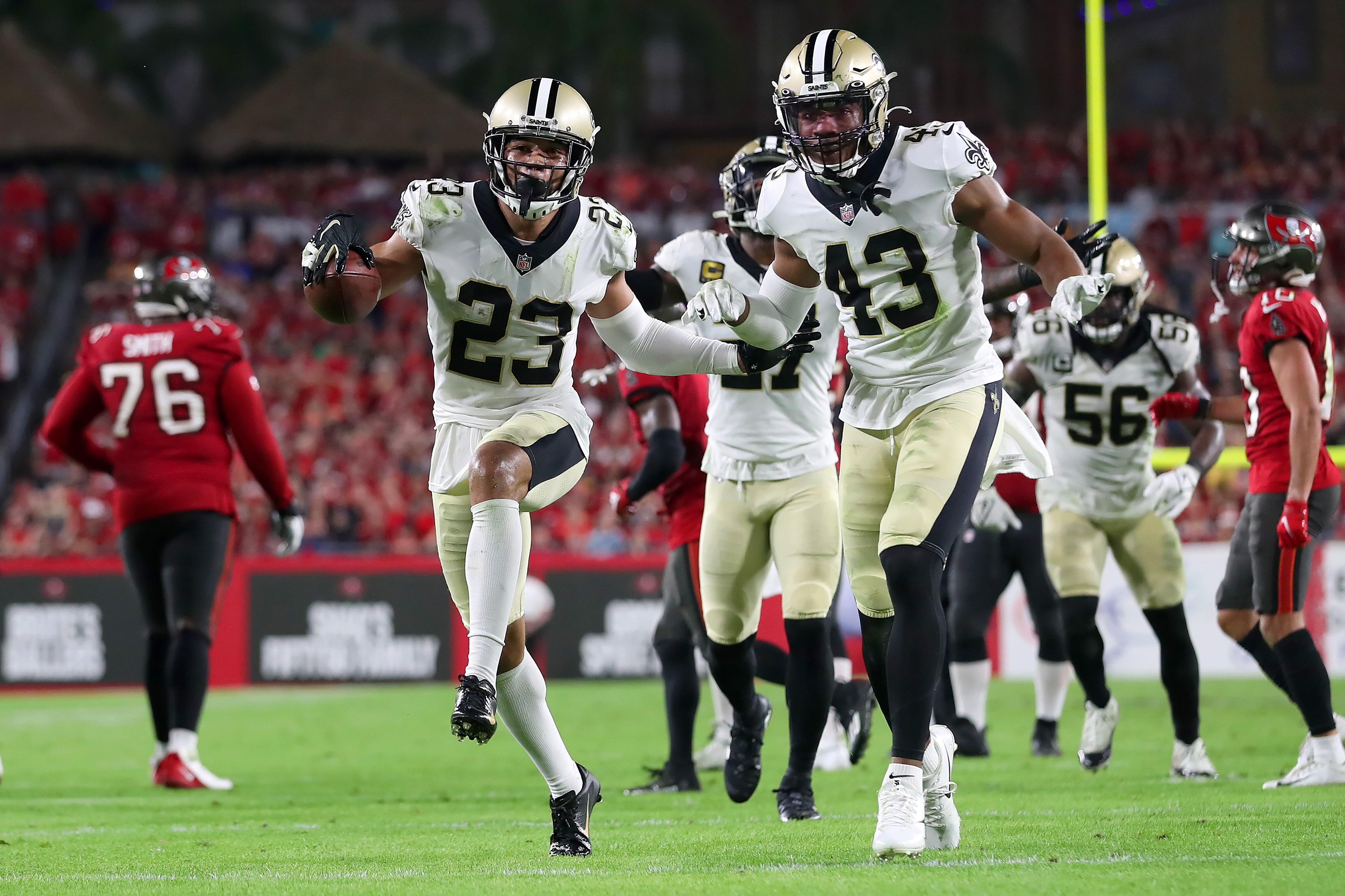 TAMPA, FL - DECEMBER 19: New Orleans Saints Cornerback Marshon Lattimore (23) celebrates a fumble recovery with Safety Marcus Williams (43) during the regular season game between the New Orleans Saints and the Tampa Bay Buccaneers on December 19, 2021 at Raymond James Stadium in Tampa, Florida. (Photo by Cliff Welch/Icon Sportswire via Getty Images)