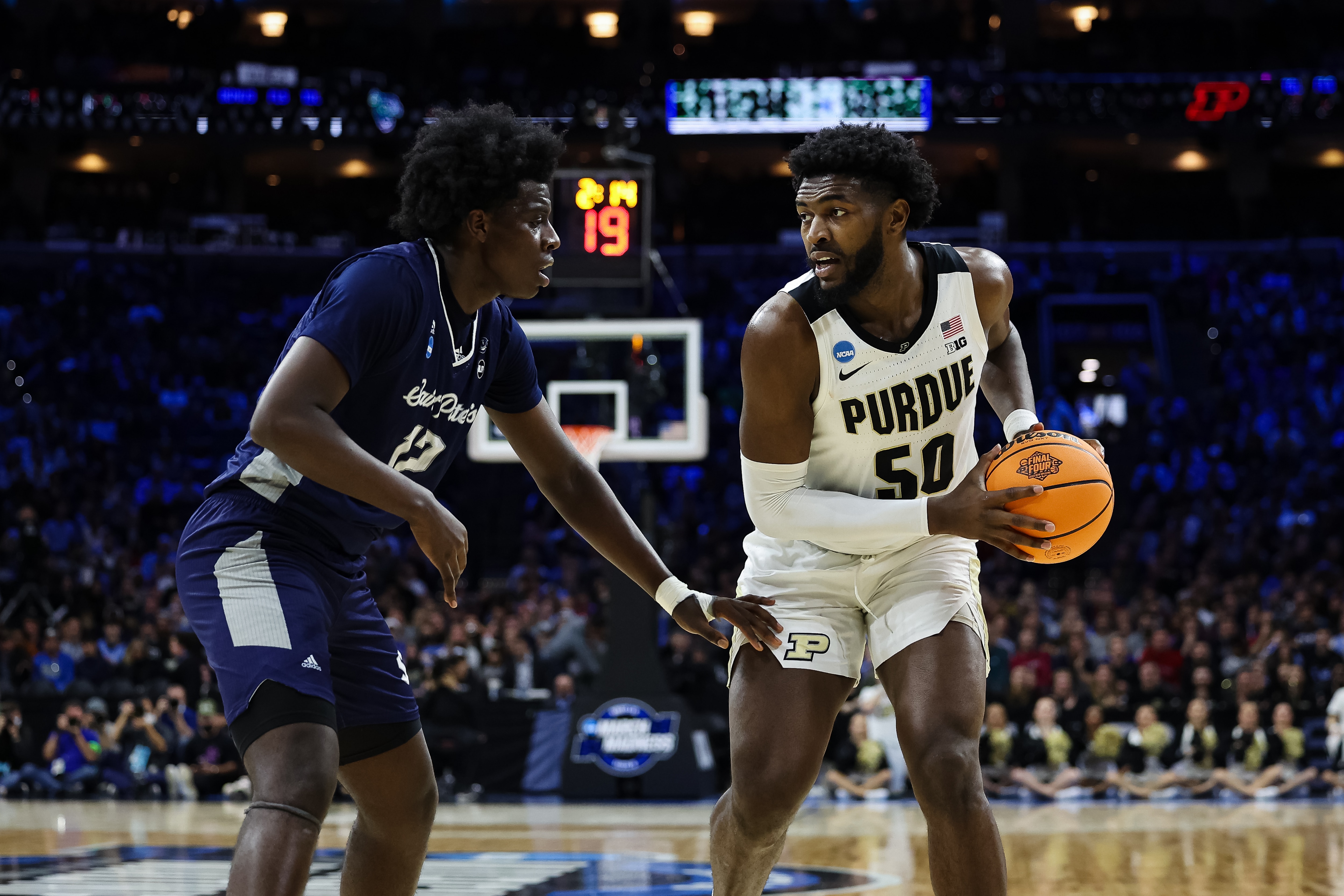 PHILADELPHIA, PA - MARCH 25: Clarence Rupert #12 of the St. Peter's Peacocks defends Trevion Williams #50 of the Purdue Boilermakers during the Sweet 16 round of the 2022 NCAA Men's Basketball Tournament held at Wells Fargo Center on March 25, 2022 in Philadelphia, Pennsylvania. (Photo by Scott Taetsch/NCAA Photos via Getty Images)