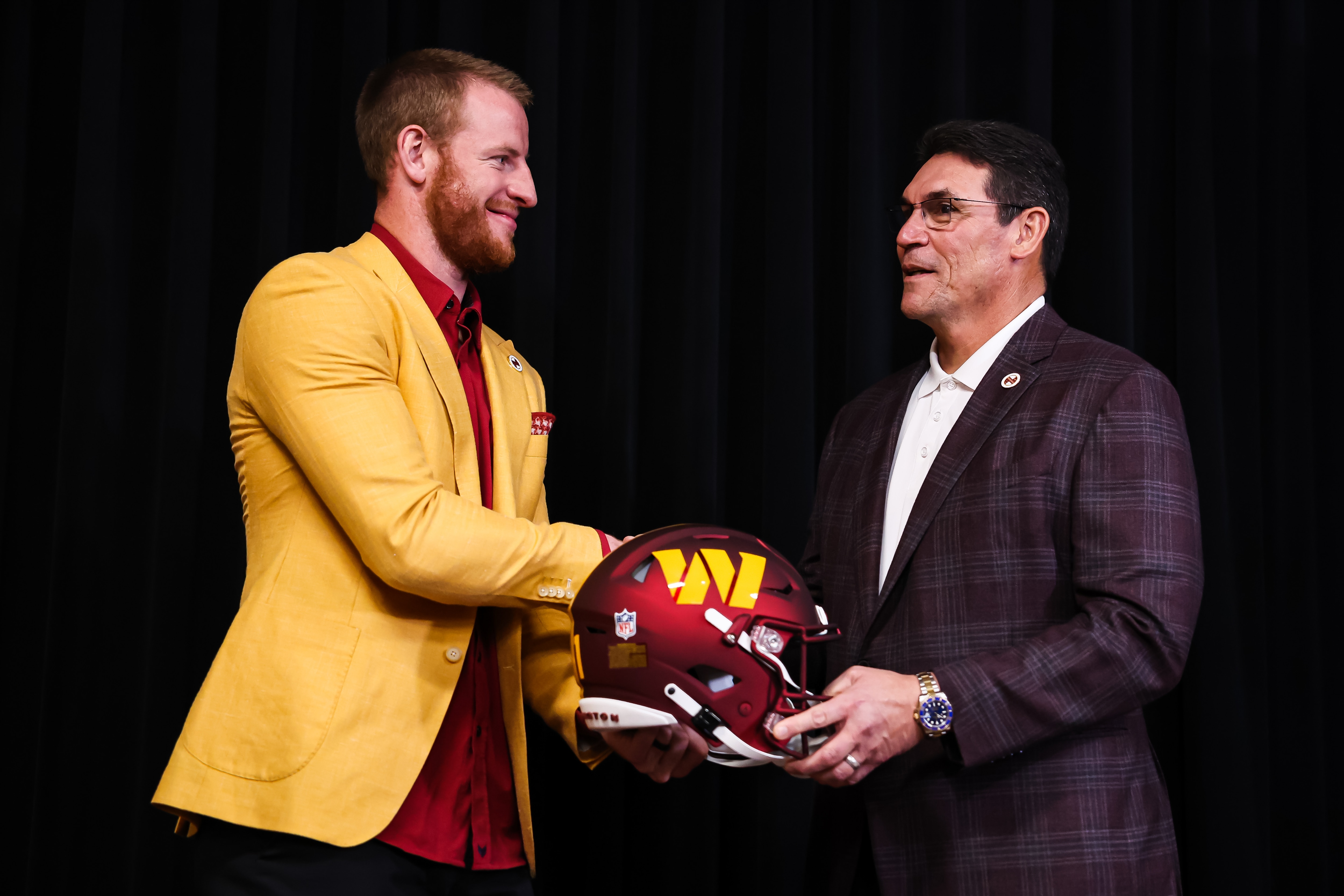 ASHBURN, VA - MARCH 17: Quarterback Carson Wentz of the Washington Commanders shakes hands with head coach Ron Rivera after being introduced at Inova Sports Performance Center on March 17, 2022 in Ashburn, Virginia. (Photo by Scott Taetsch/Getty Images)