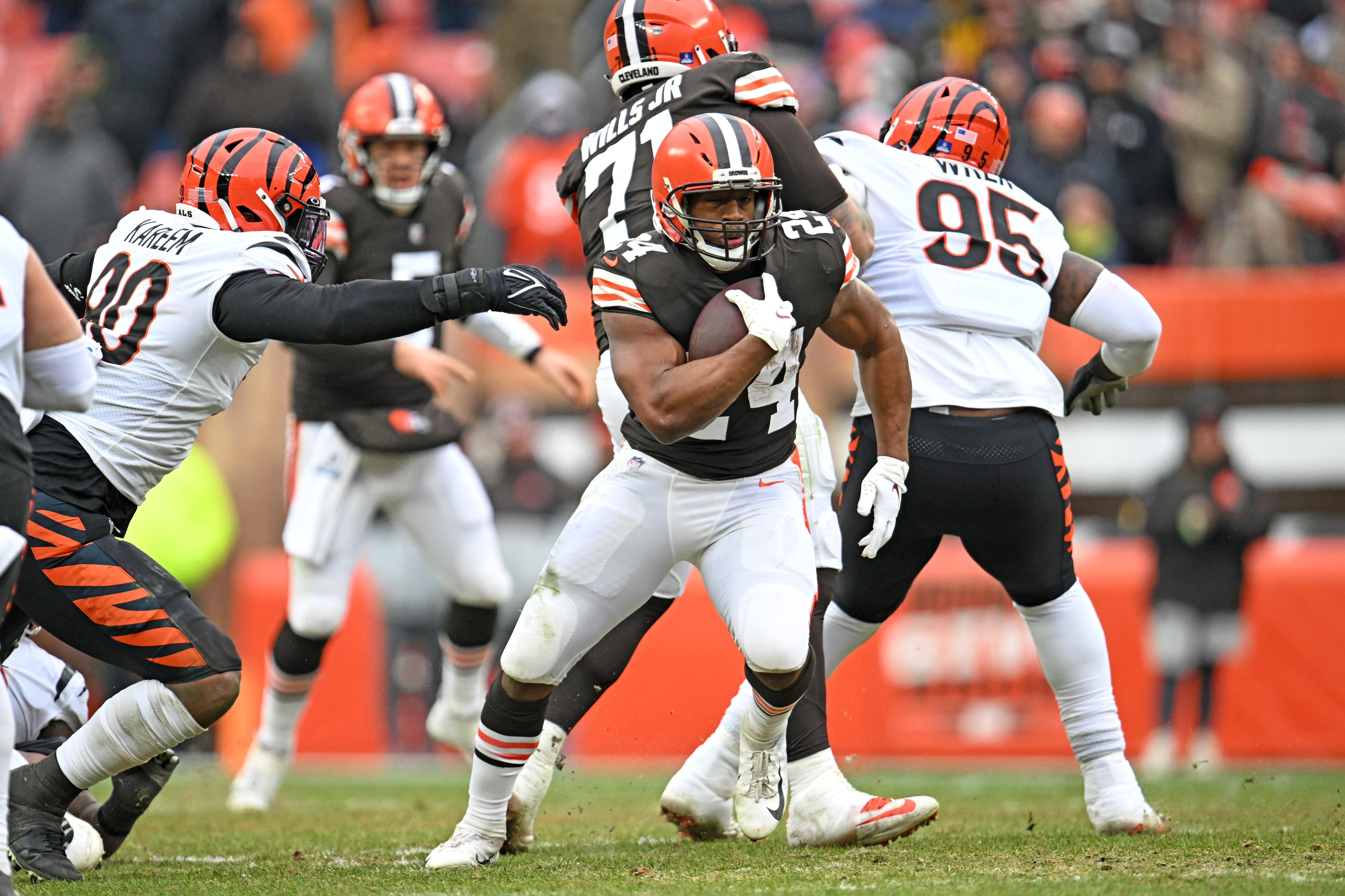 CLEVELAND, OHIO - JANUARY 09: Defensive end Khalid Kareem #90 of the Cincinnati Bengals tries to stop running back Nick Chubb #24 of the Cleveland Browns during the second half at FirstEnergy Stadium on January 09, 2022 in Cleveland, Ohio. The Browns defeated the Bengals 21-16. (Photo by Jason Miller/Getty Images)